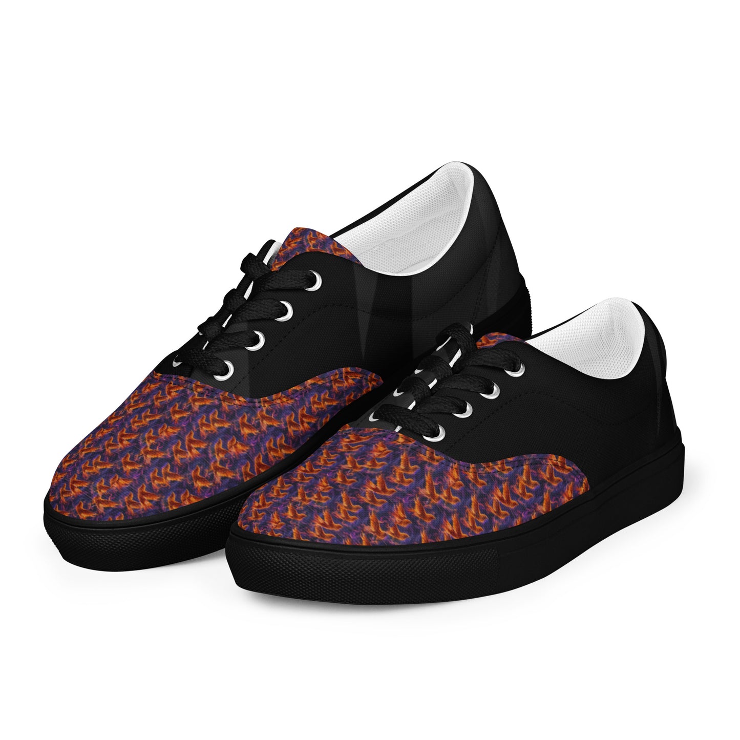 Angled view of black lace-up canvas sneakers with orange-blue flame toe pattern