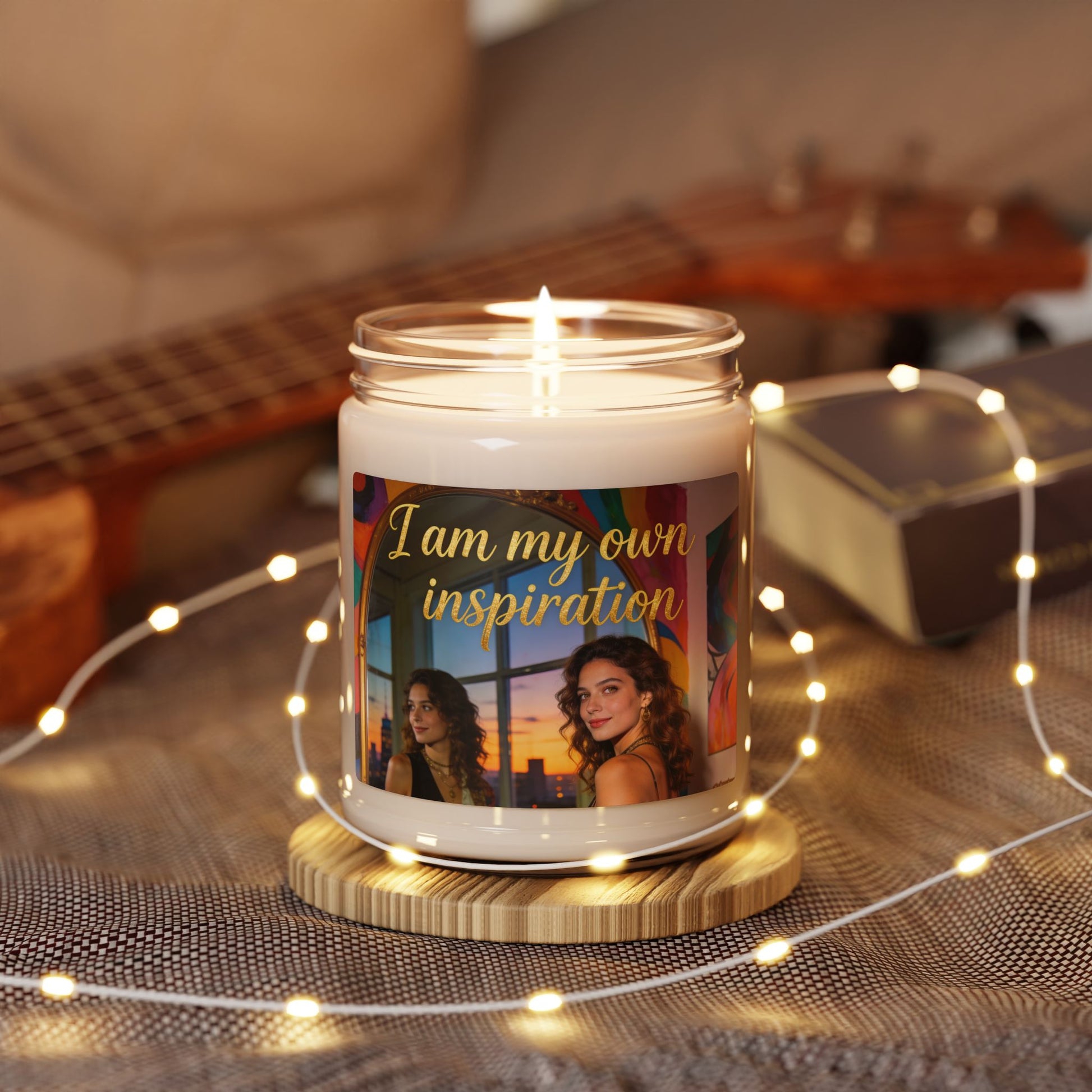 Lit soy candle in clear glass jar with 'I am my own inspiration' label