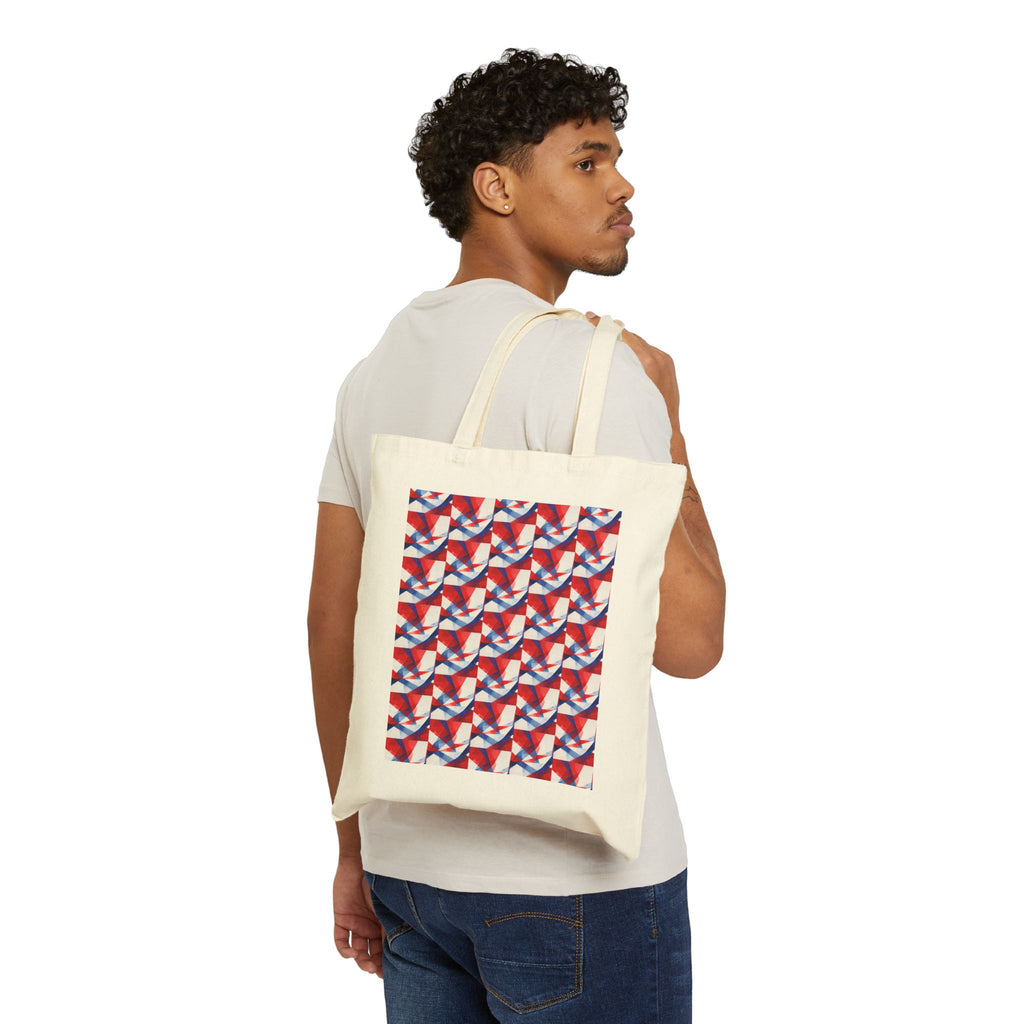 Natural canvas tote worn by man; red-white-blue geometric flag print on front.