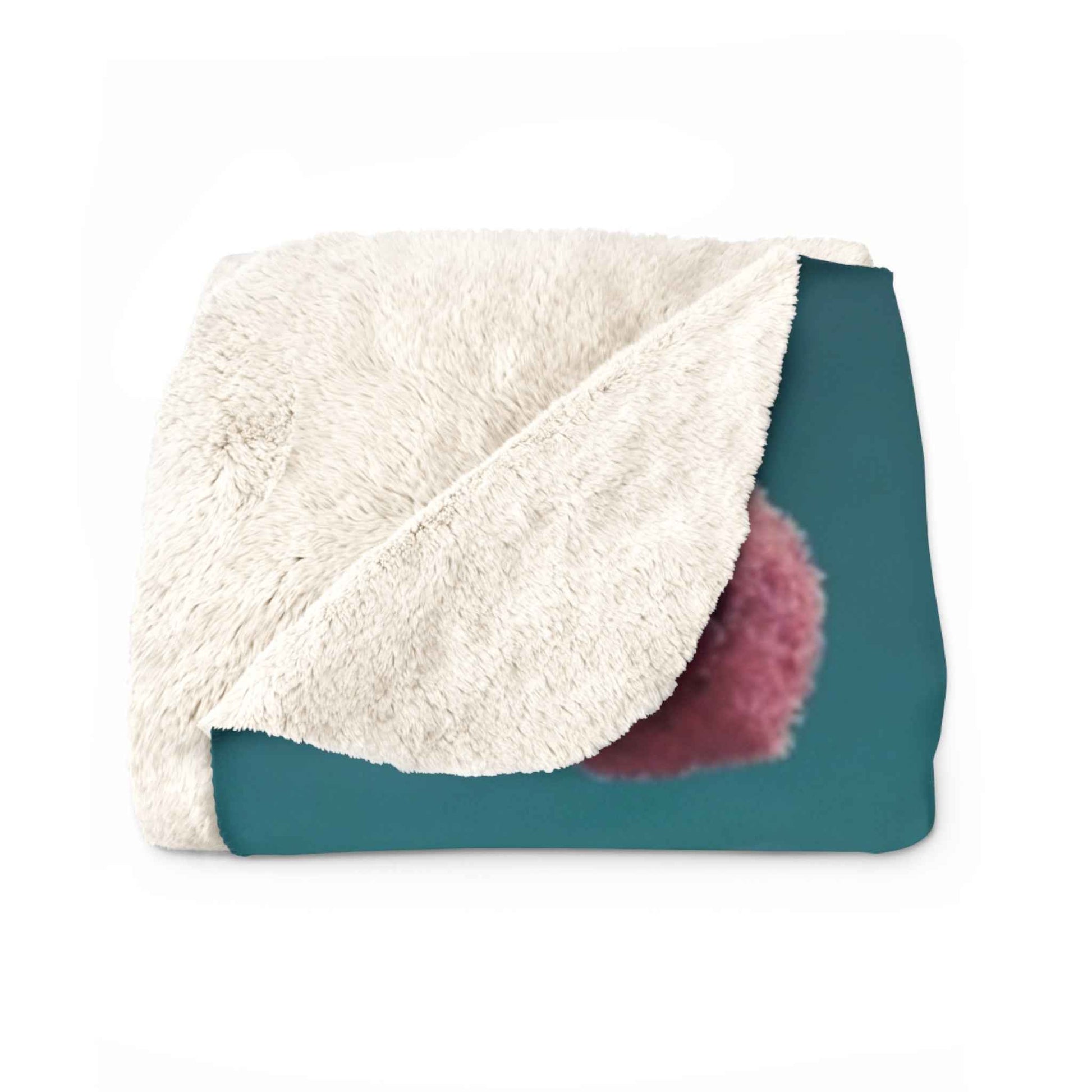 Cream sherpa blanket with teal backing panel and purple pom detail