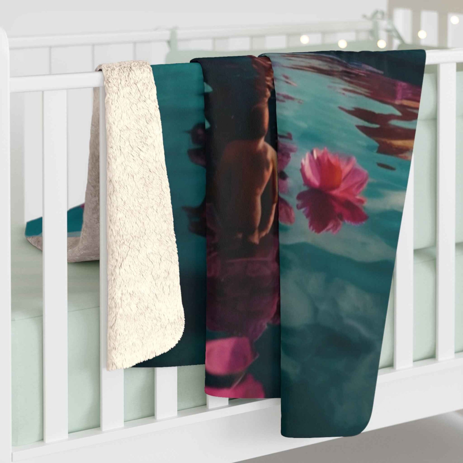 Teal fleece blanket with teal water and pink flower print, draped edge
