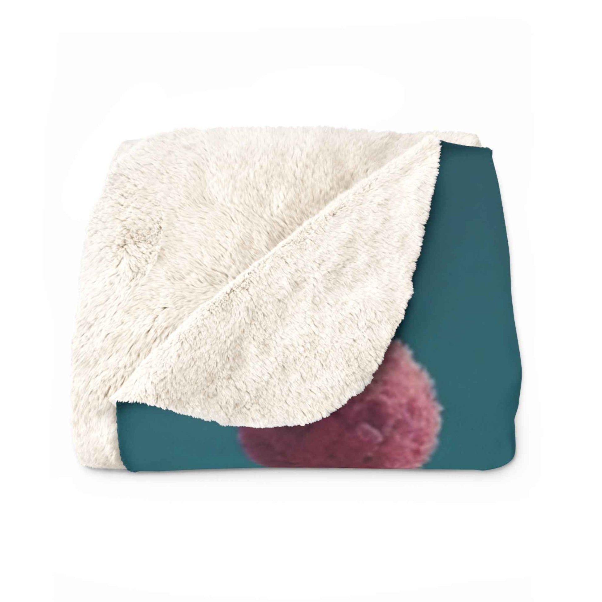 Cream sherpa throw with teal backing and rounded purple corner