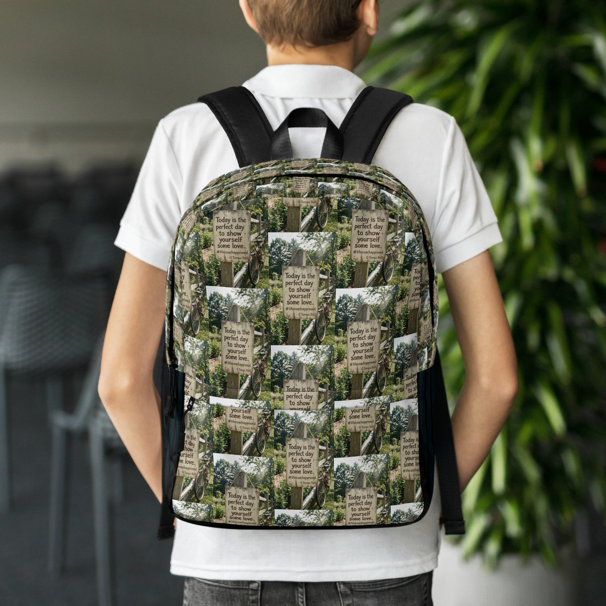 Printed canvas backpack with black shoulder straps and front panel, worn by person