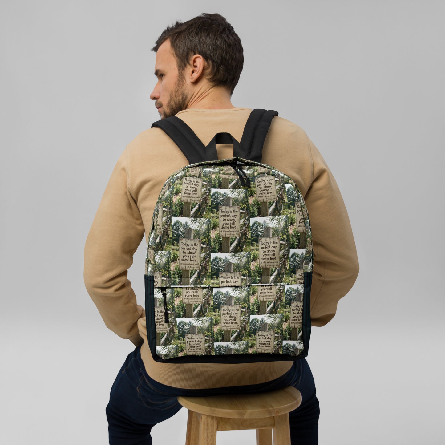 Printed canvas backpack worn from behind with black padded straps and back panel