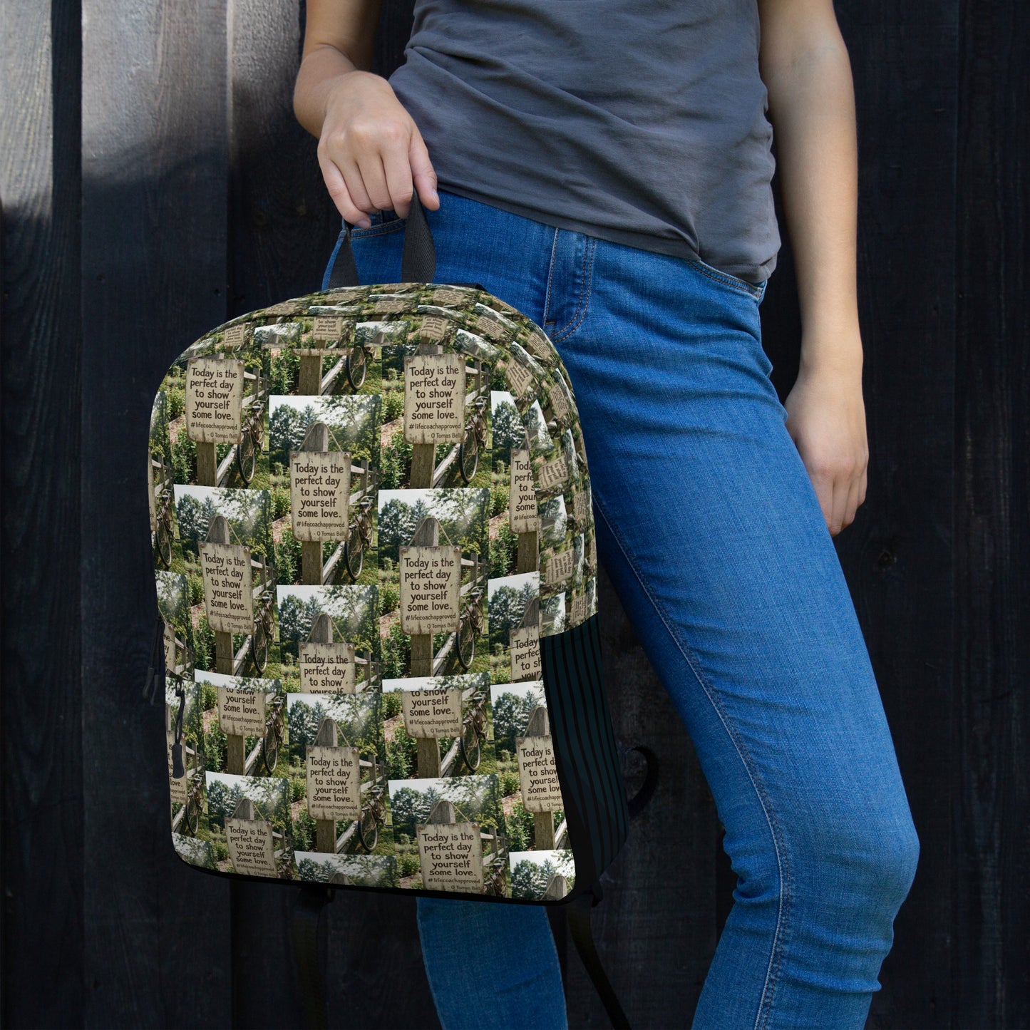 Printed canvas backpack with rounded top, black straps, and front zipper pocket