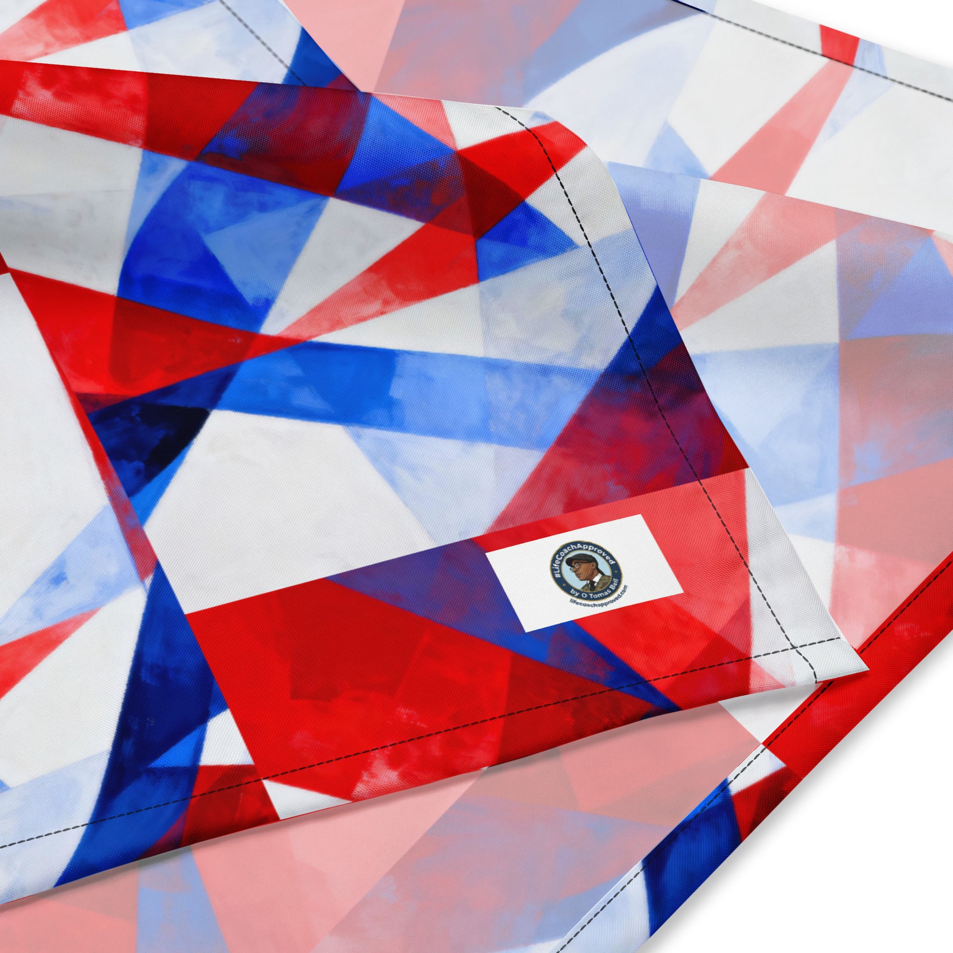 American flag print bandana fabric close-up with logo patch and curved stitched seam