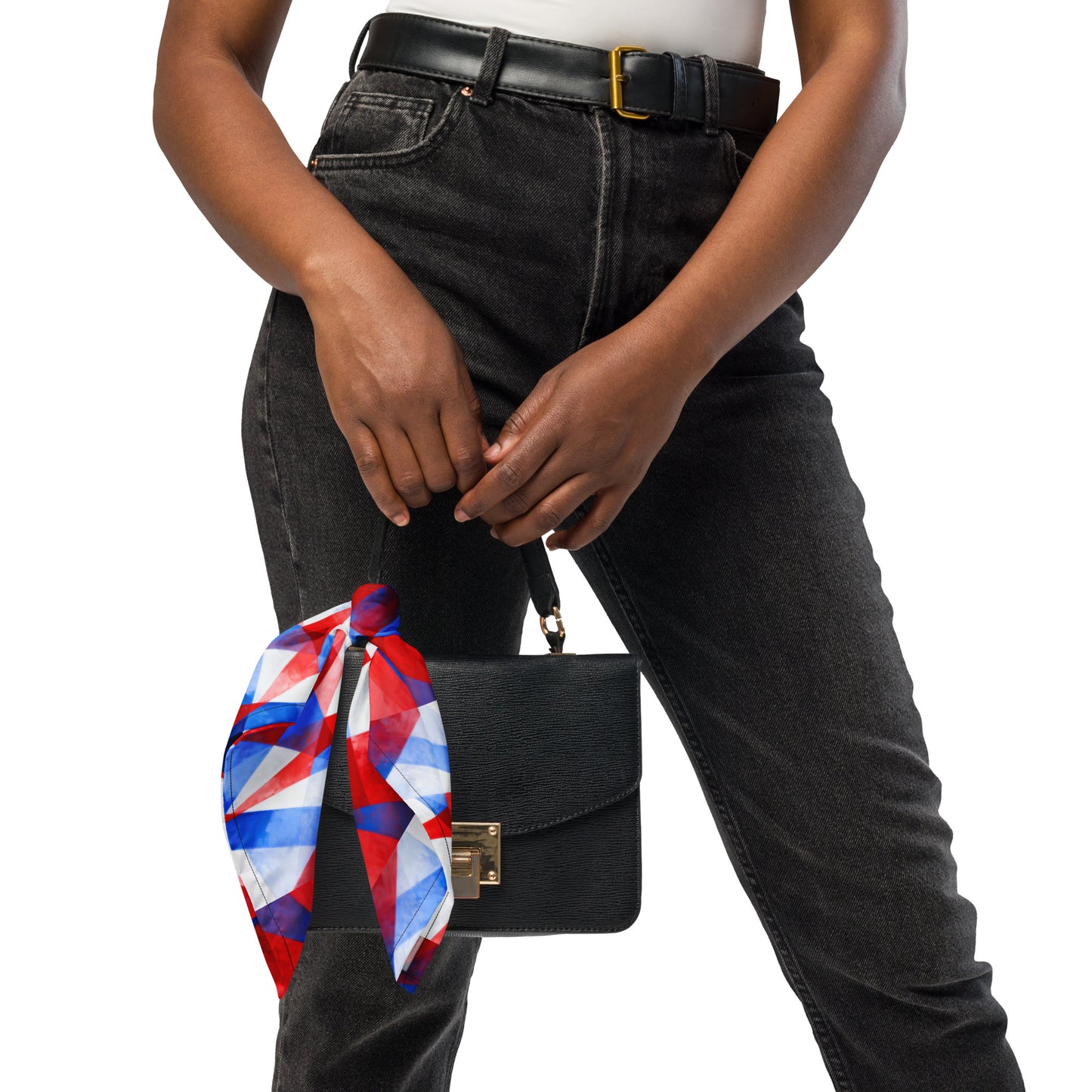 Red, white, and blue geometric bandana tied at side of black bag strap
