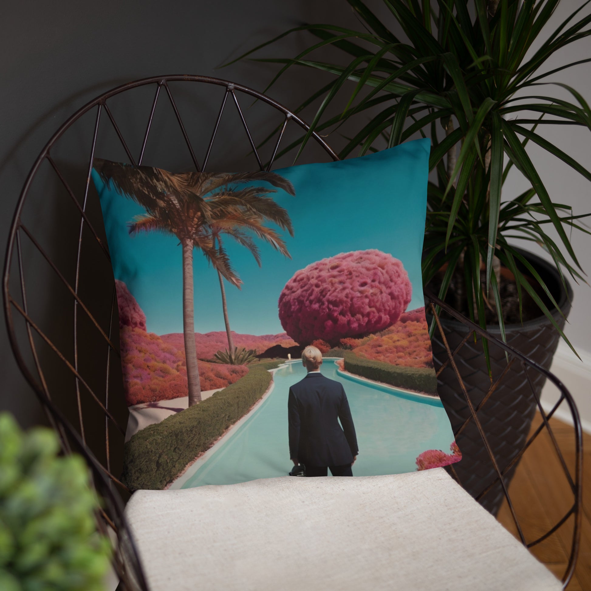 Accent pillow featuring teal desert pool scene with palm tree and pink cloudlike tree.