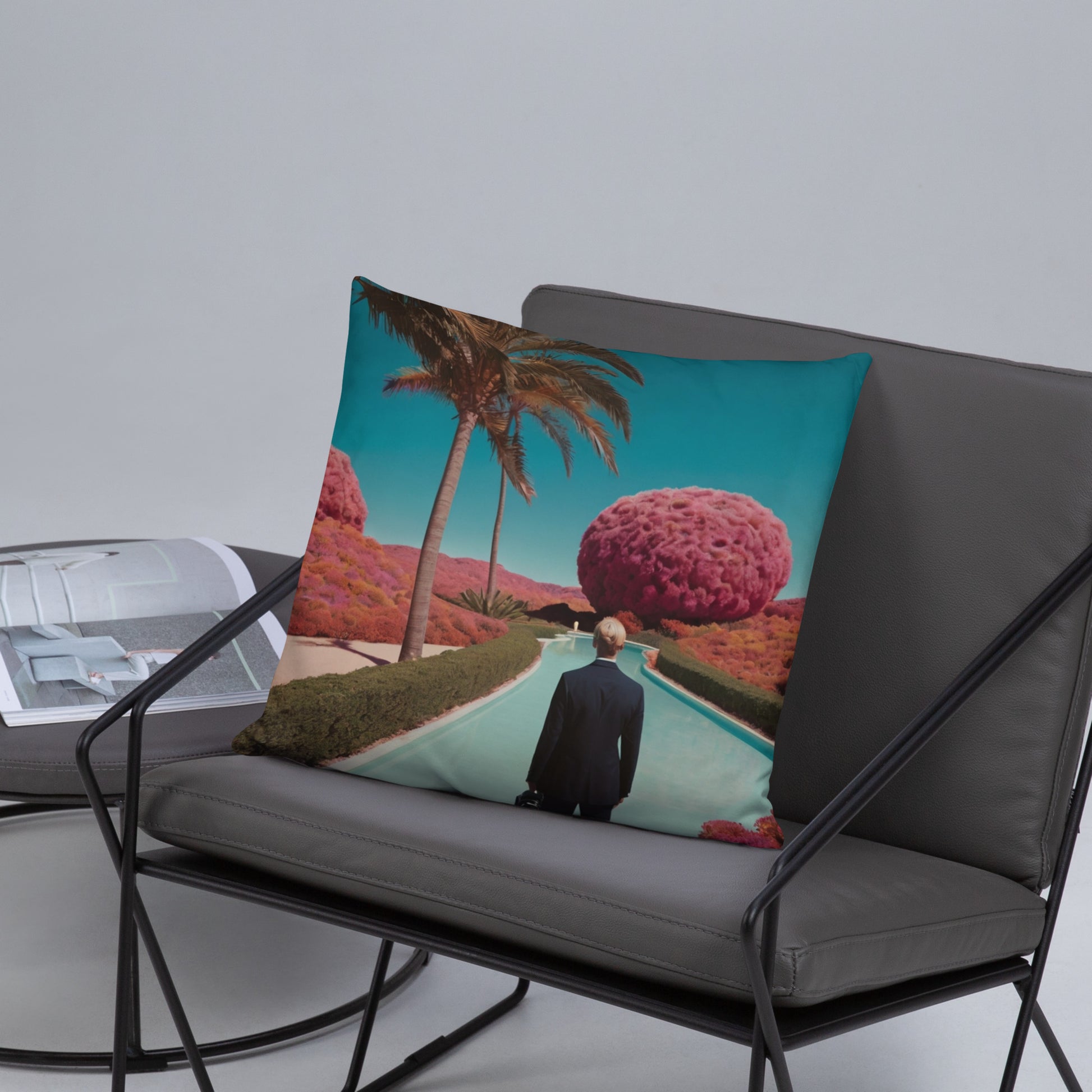 Accent pillow with teal pathway illustration, palm tree and large pink round tree.
