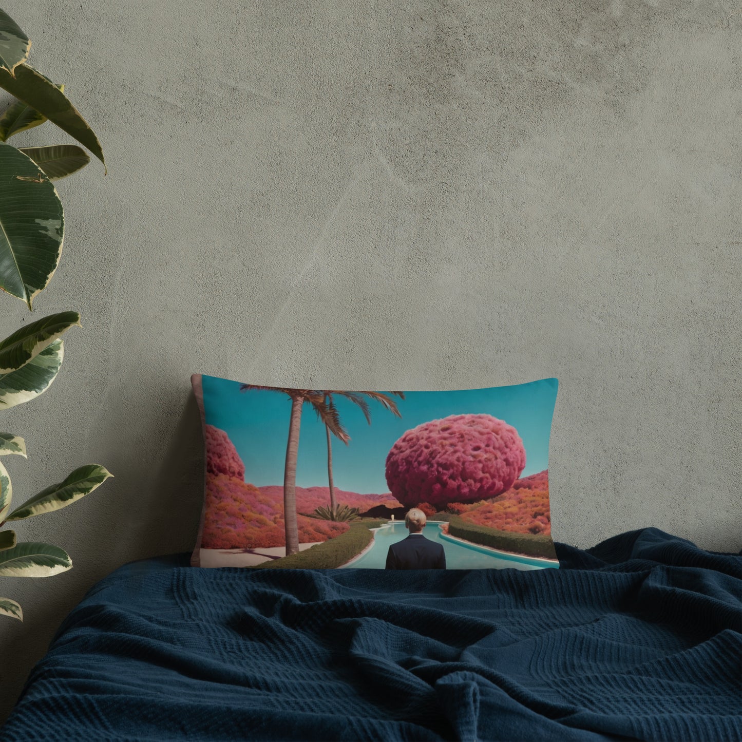 Accent pillow with teal desert-pool graphic, man silhouette and pink round tree.
