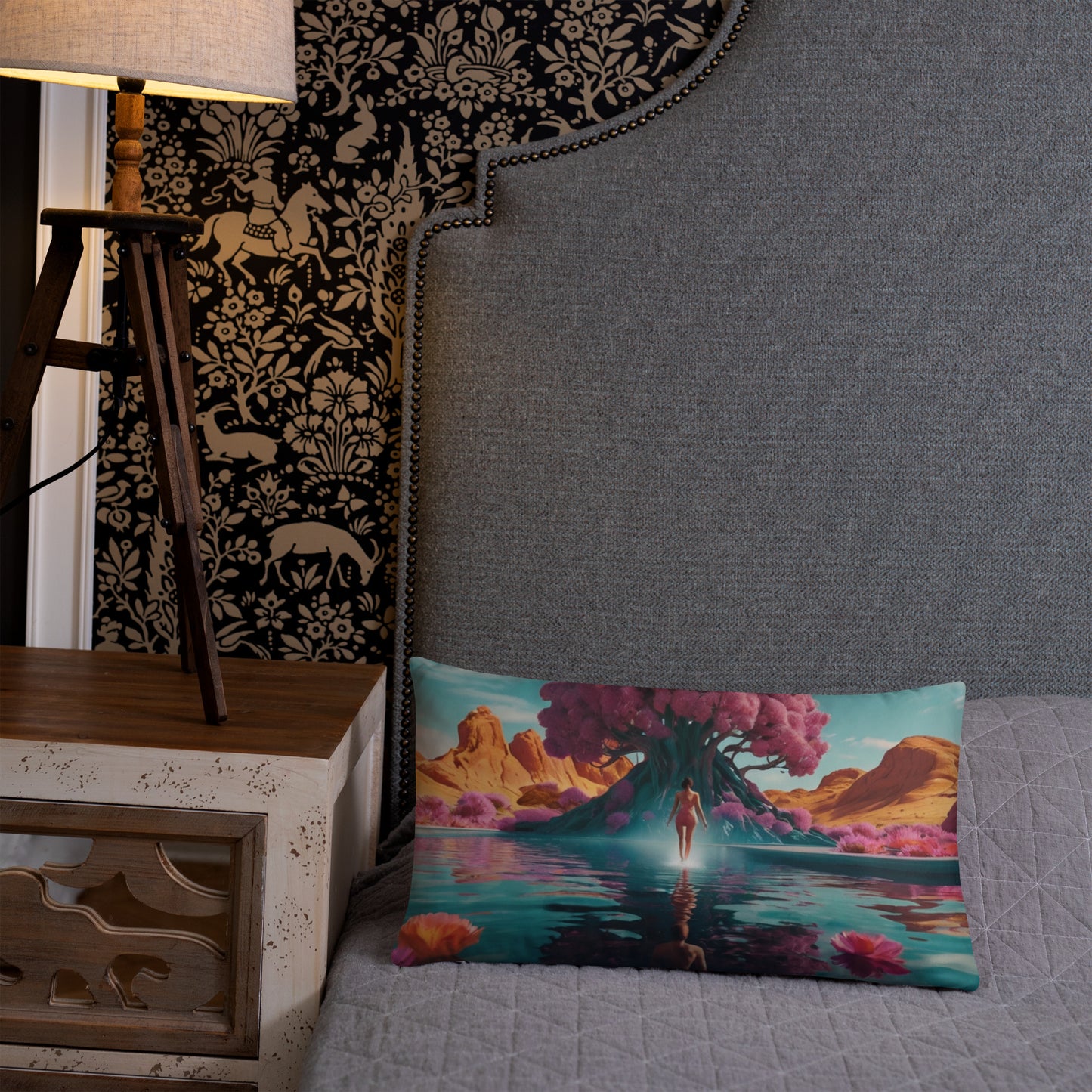 Accent pillow with teal water scene artwork, figure centered with pink flowers.