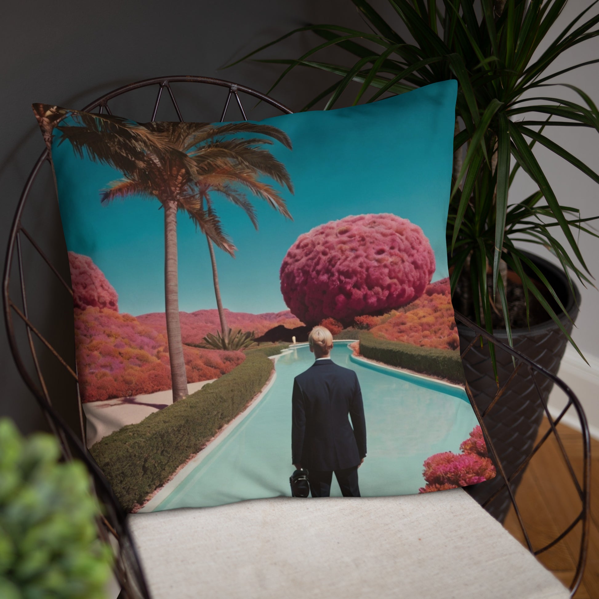 Teal accent pillow with pool walkway, palm tree, and a man viewed from behind