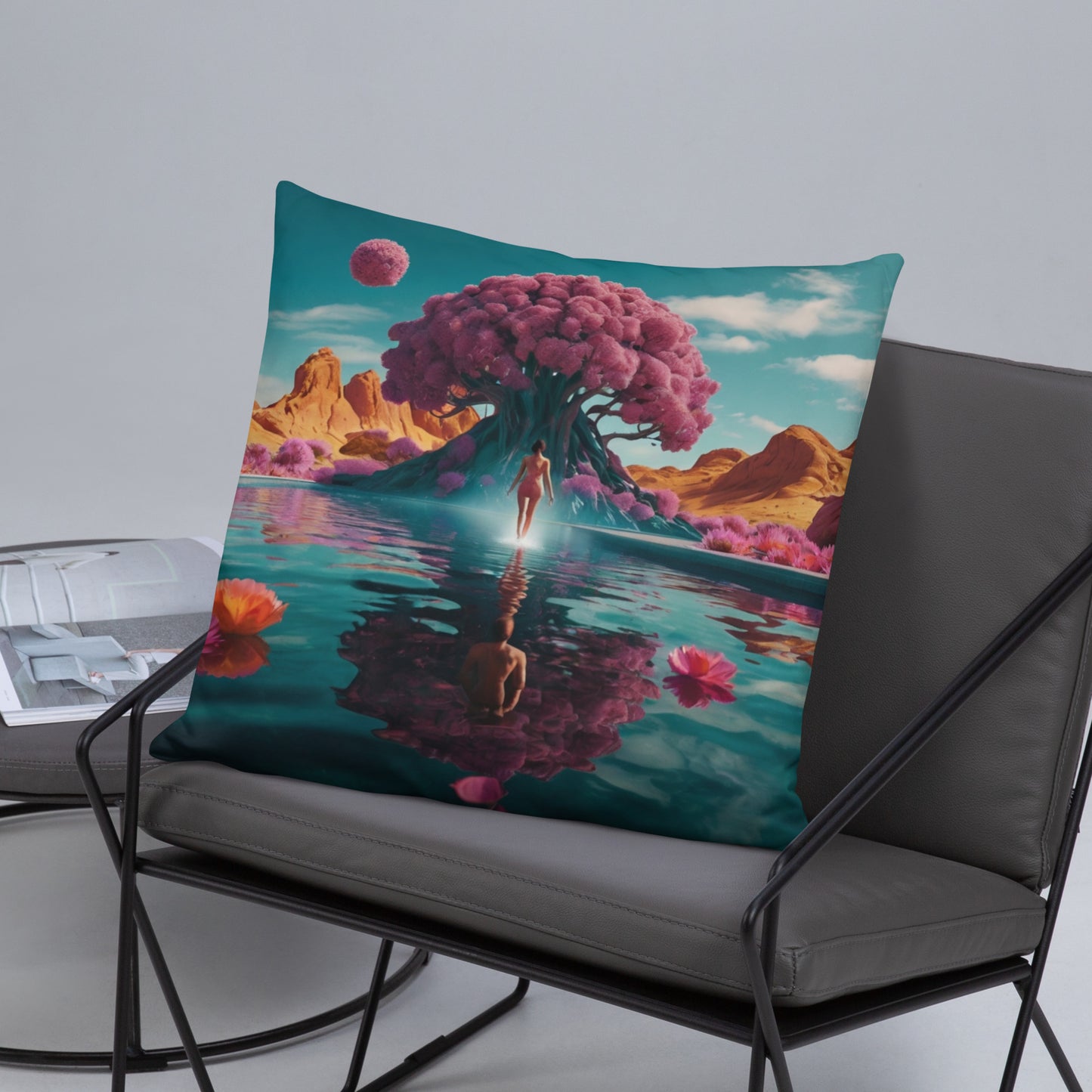 Teal accent pillow with surreal tree, standing figure, and reflection over calm water scene