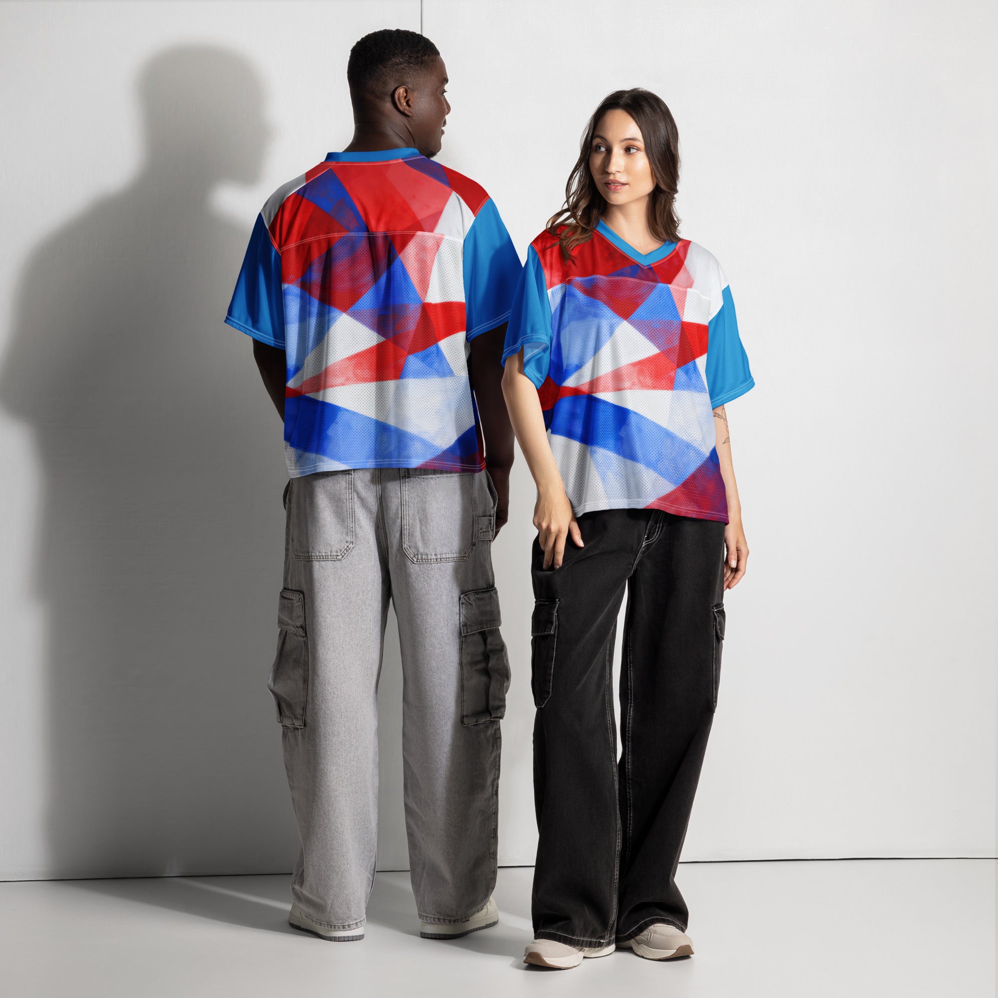 Boxy football jersey on model from back/side; red, white, and blue geometric print; V-neck