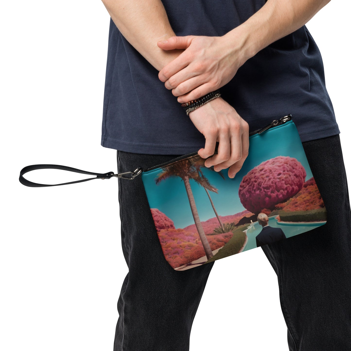 Teal crossbody bag with zipper and scenic print, close-up worn with dark pants