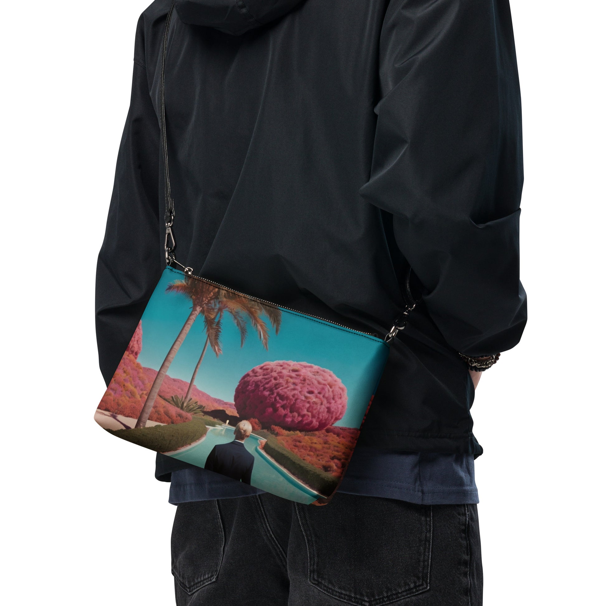 Teal crossbody bag with zipper and scenic print, side view across torso