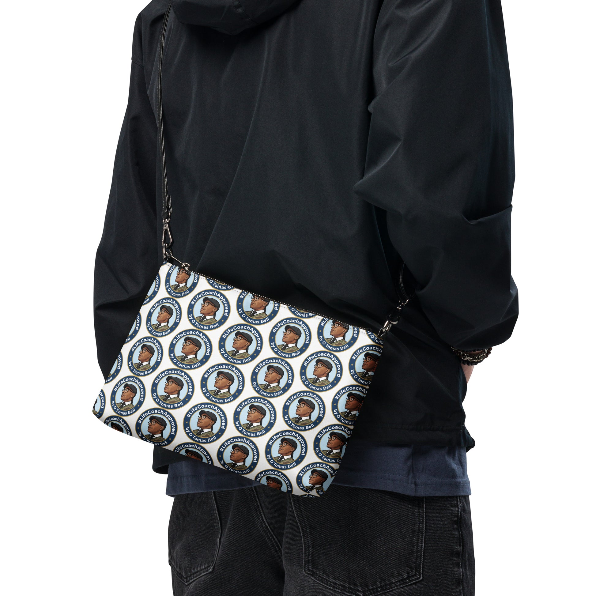 Printed crossbody bag worn with black strap and zipper top, blue circular pattern on front