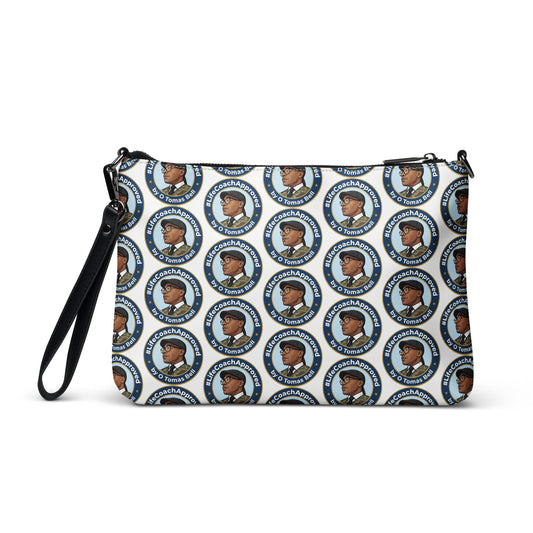 Printed crossbody bag with black strap and top zipper, blue circular pattern all over