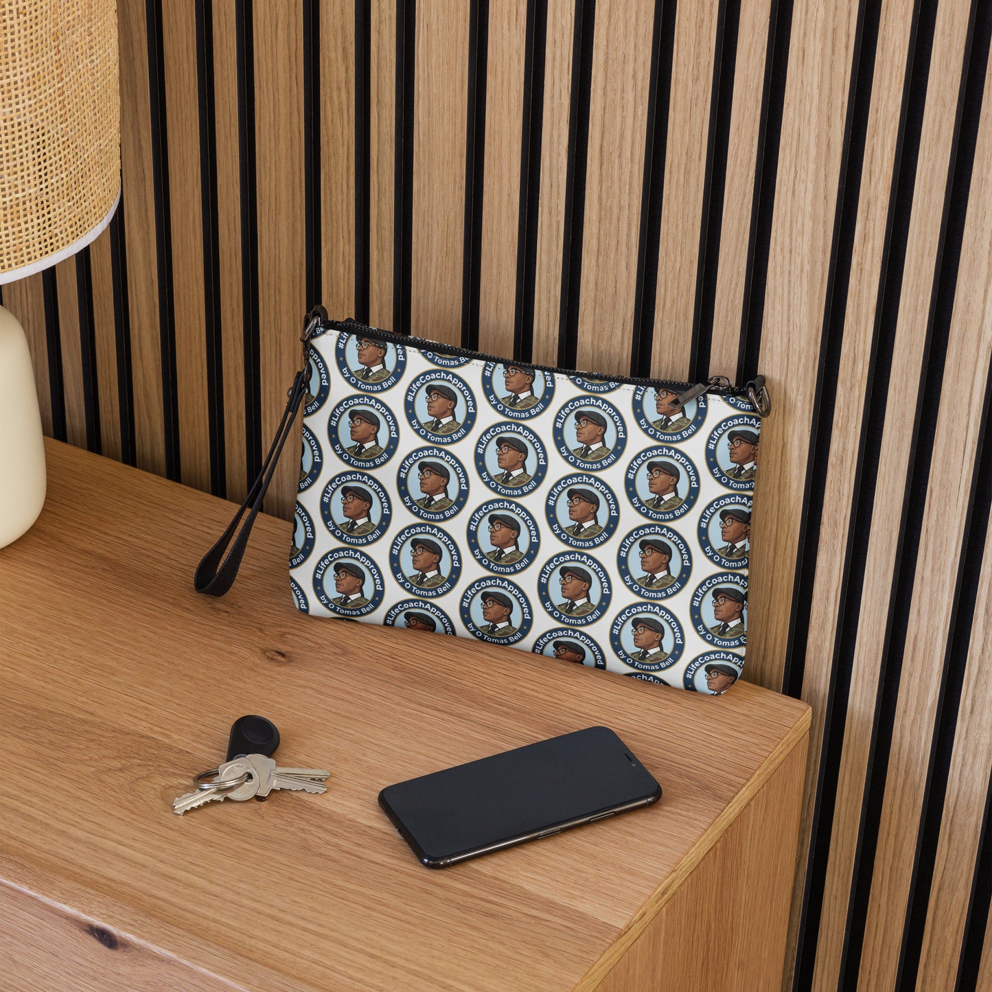 Pattern crossbody bag with zip closure and black wrist strap, circular portrait print