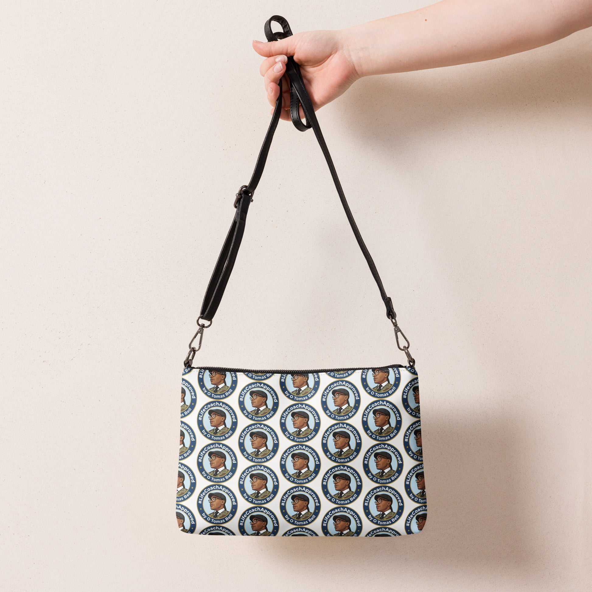 Pattern crossbody bag with long black strap and zip top, circular portrait print