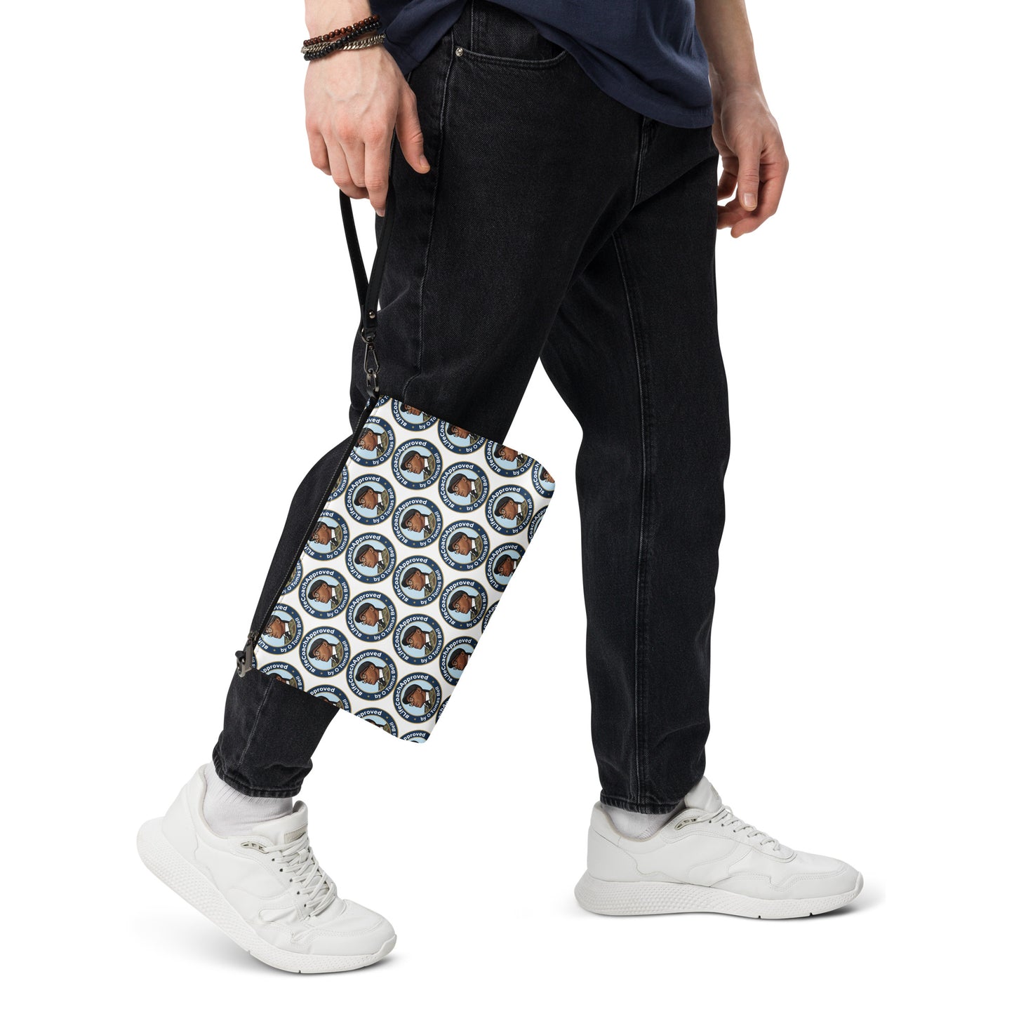 Printed crossbody bag worn at hip, black trim and zipper top with blue circular pattern