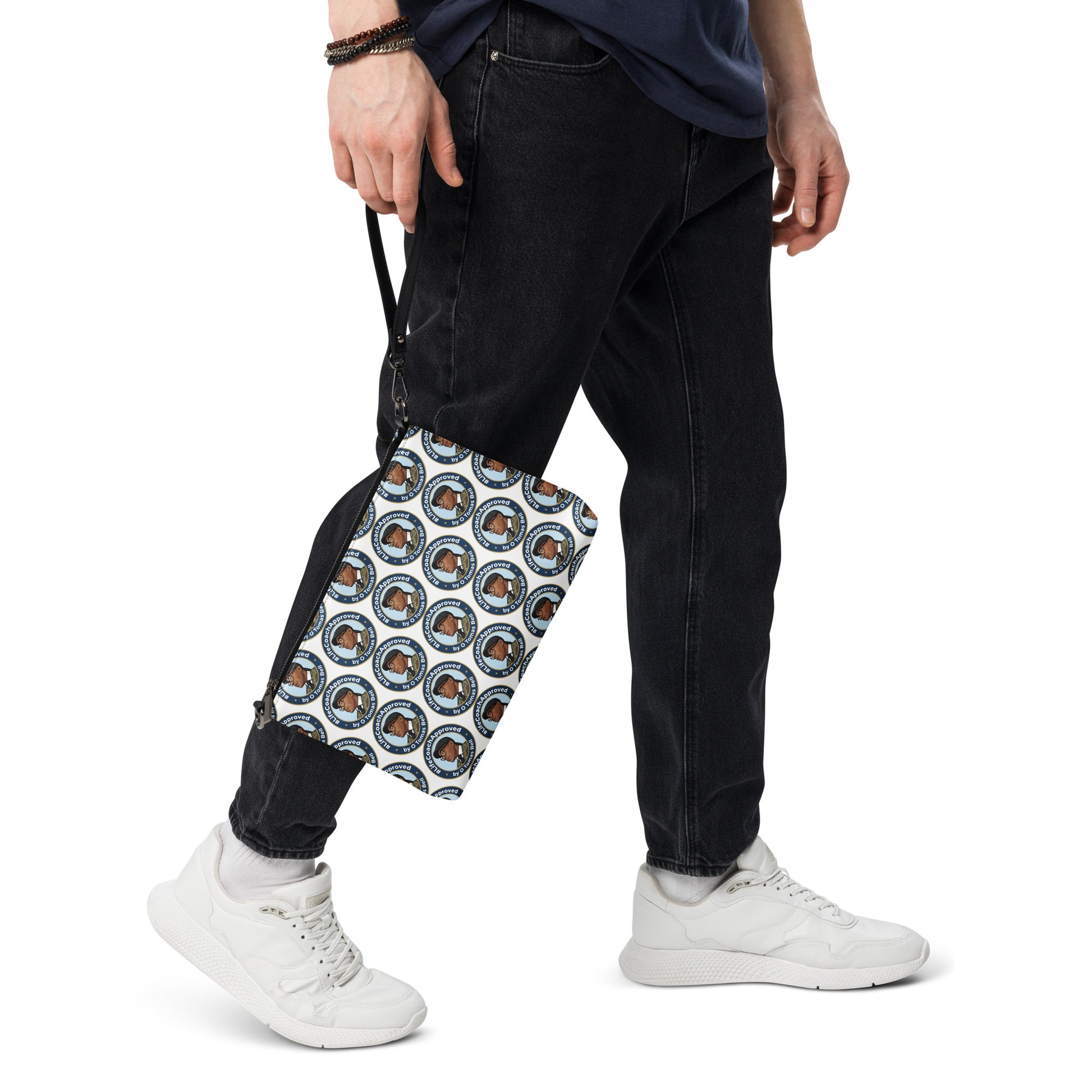 Printed crossbody bag worn at hip, black trim and zipper top with blue circular pattern