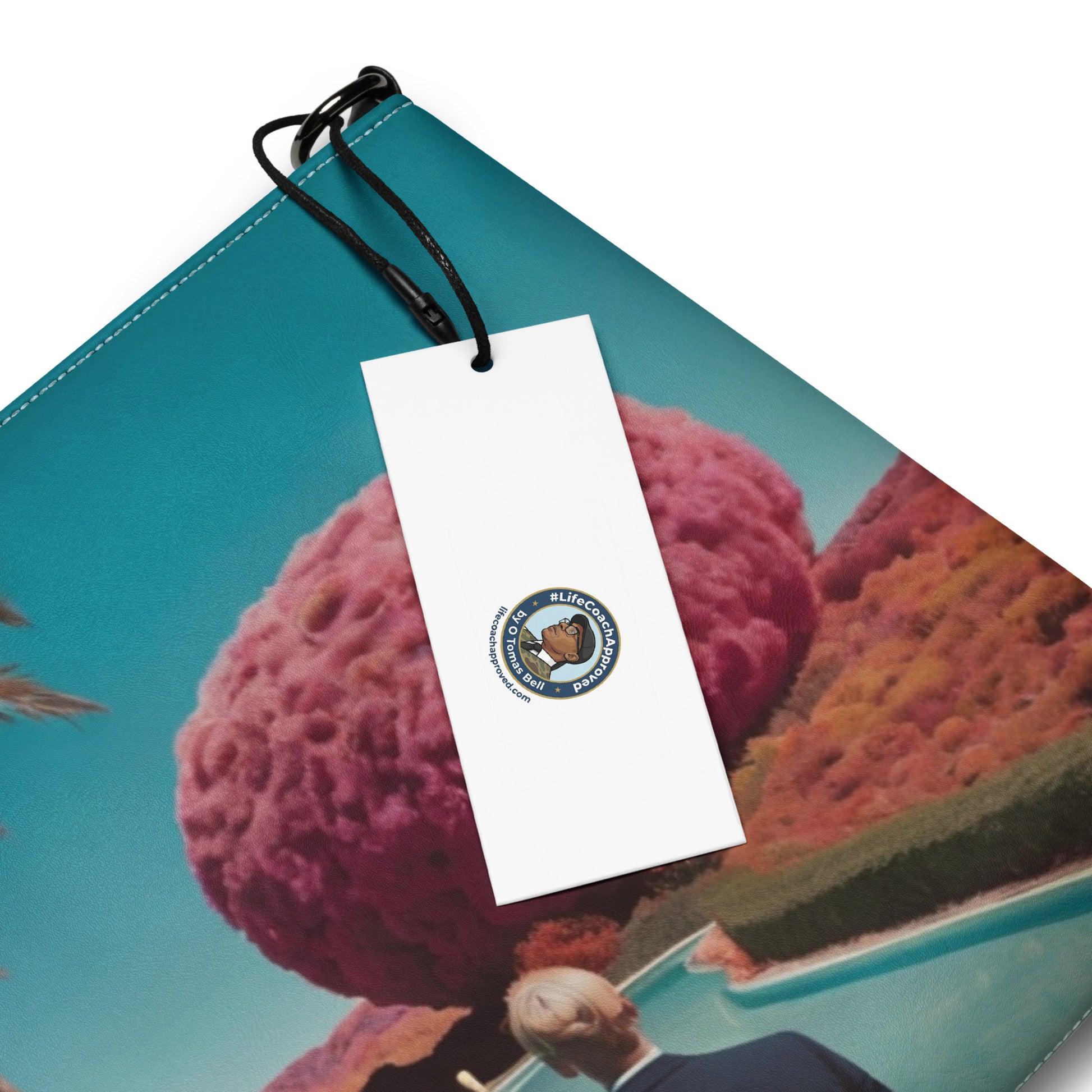 Unisex crossbody bag with teal scenic print and white hang tag on black loop.