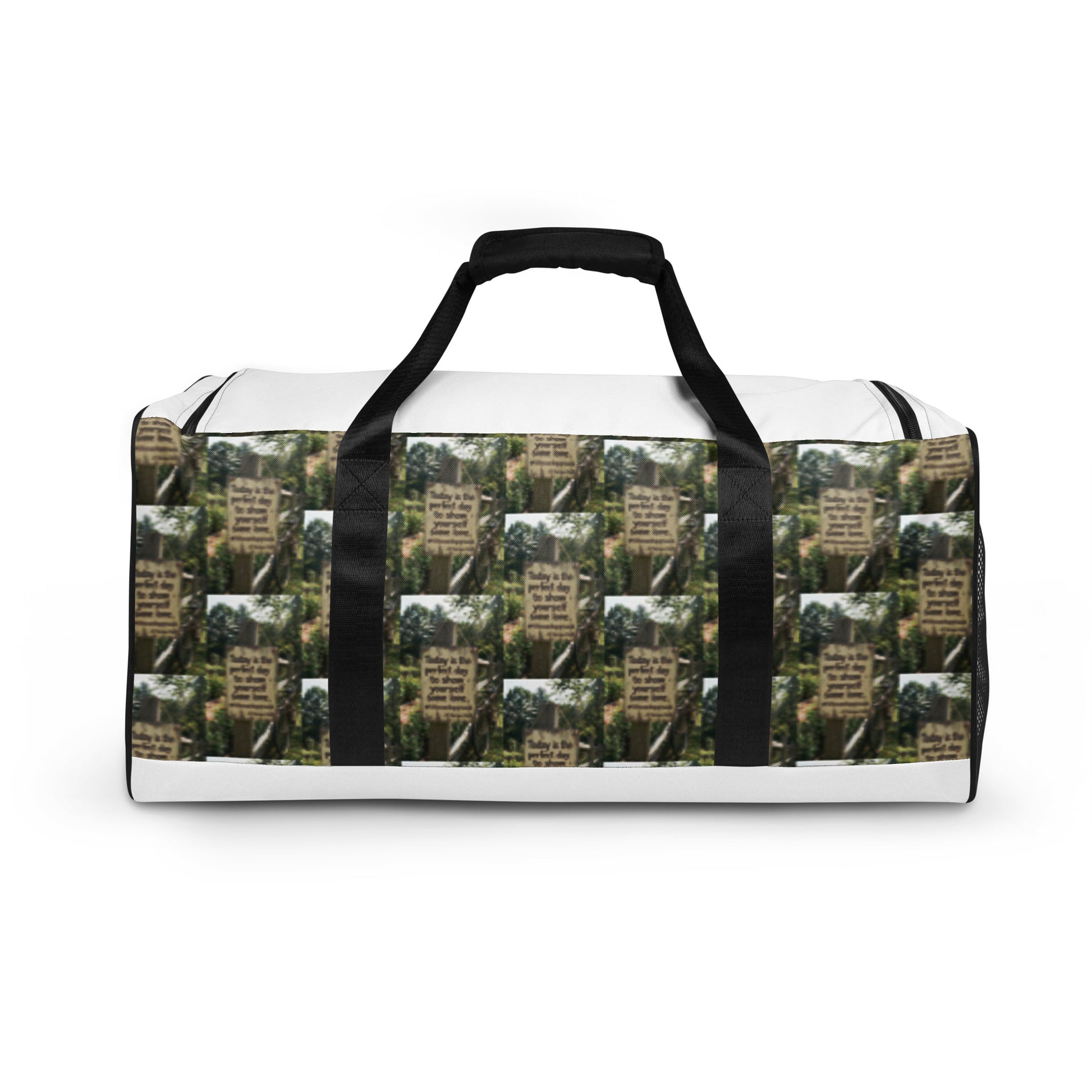 Duffle bag with white panels and black handles; green tree-text pattern body with black trim.