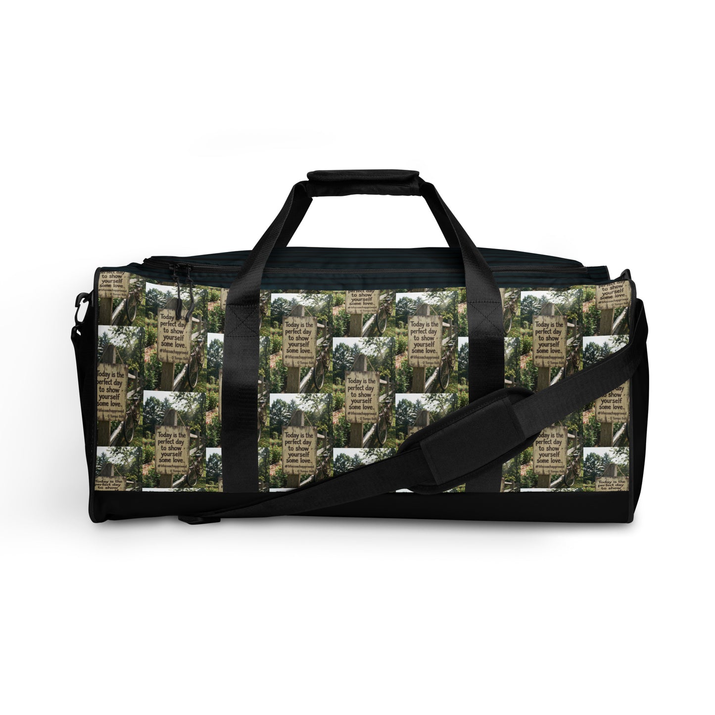 Black duffle bag with green collage side panel and long shoulder strap