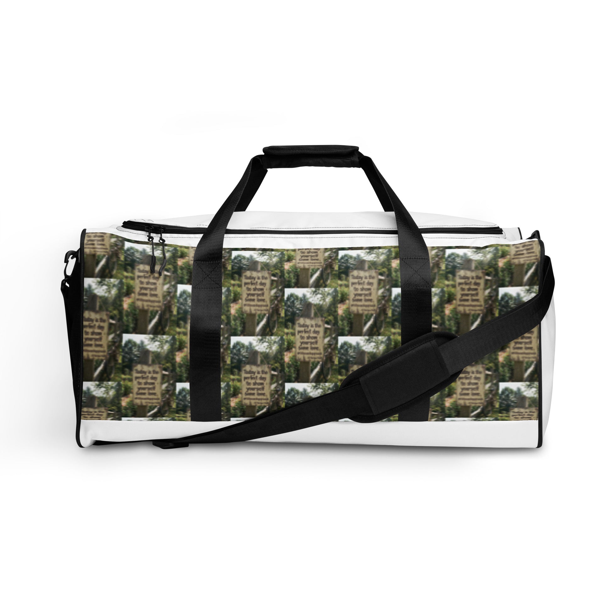 Duffle bag with adjustable shoulder strap; white trim and green tree-text pattern fabric.