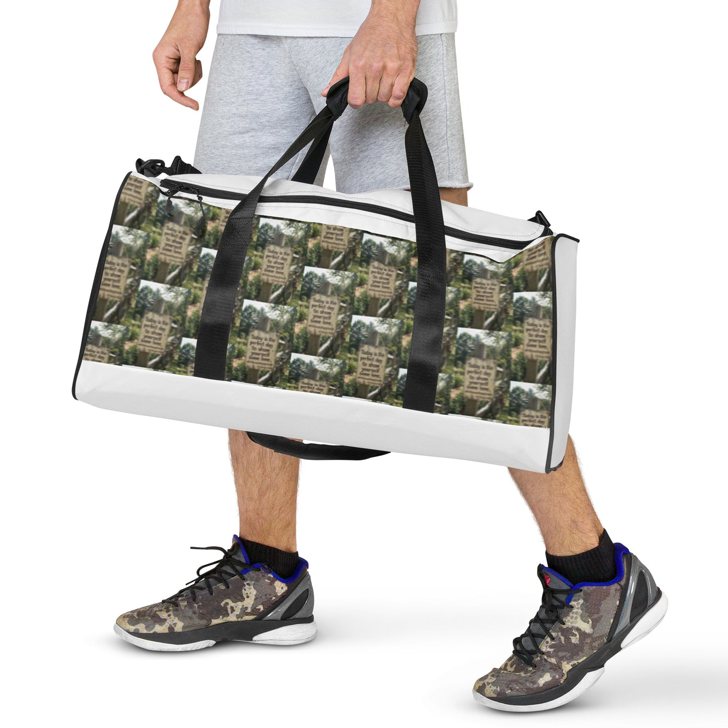 White and black duffle bag with city-style graphic print and black carry handles