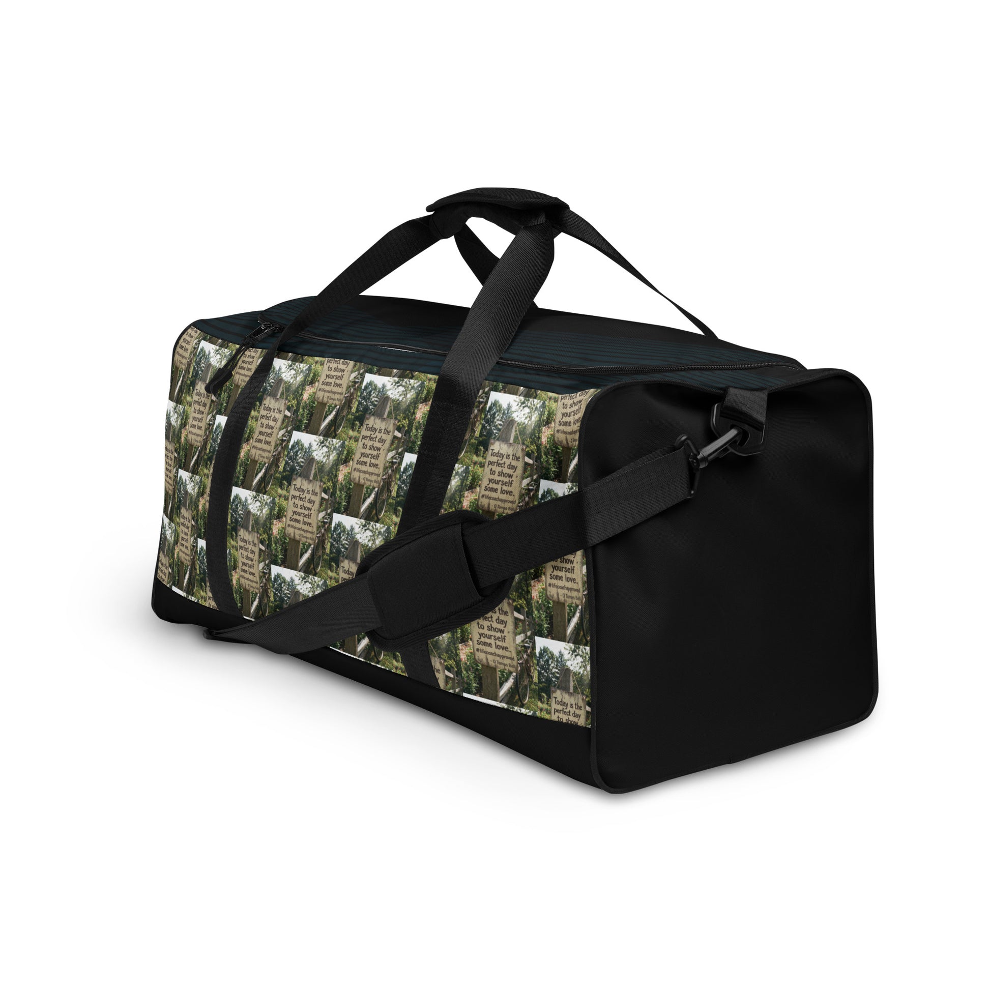 Black duffle bag with green collage exterior and adjustable shoulder strap