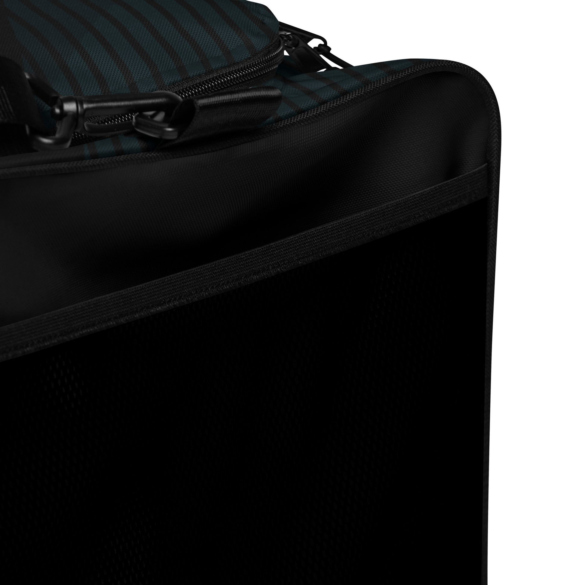 Black duffle bag close-up of side panel with zipper and smooth fabric texture.