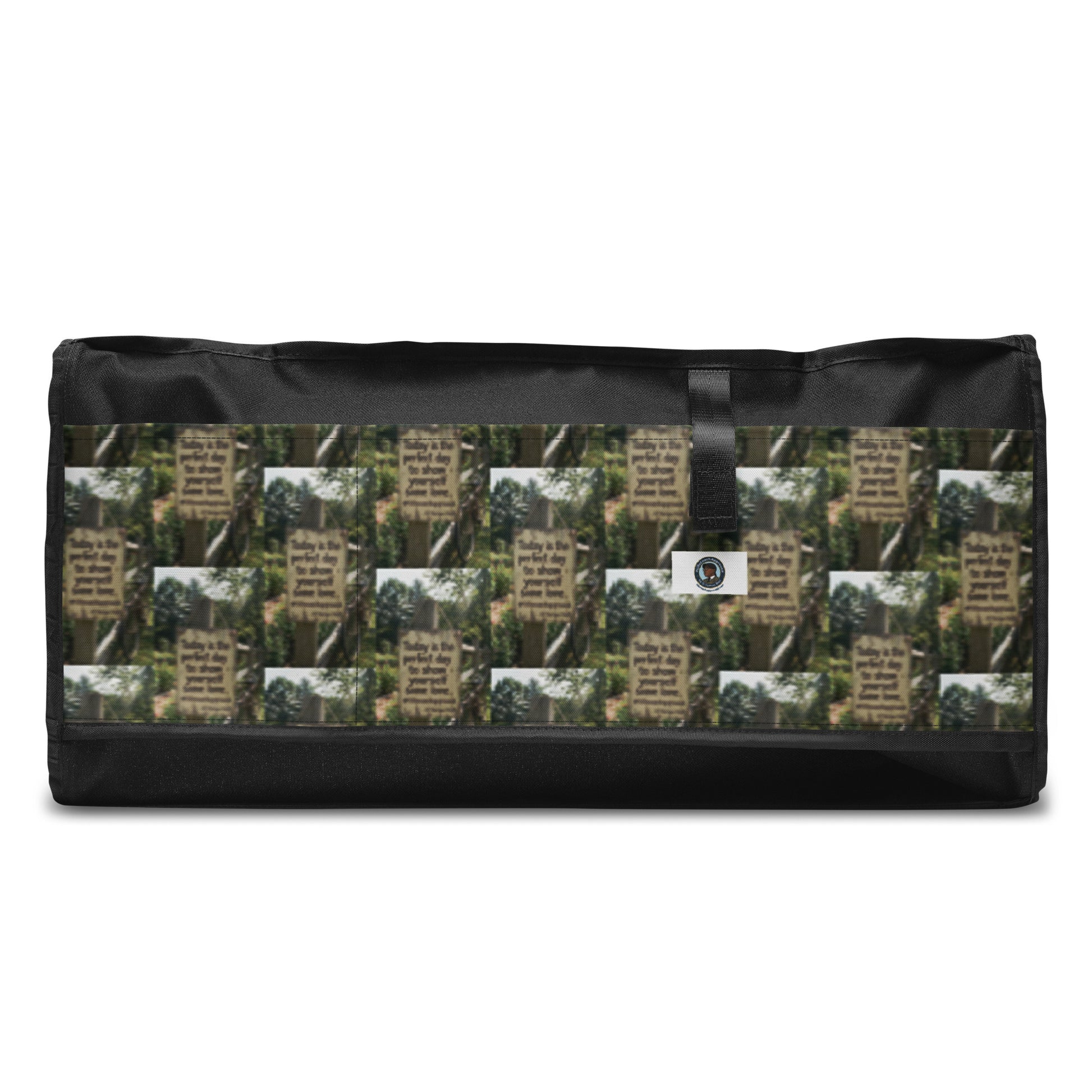 Rectangular duffle bag with black base, white sides, and green-brown graphic front panel