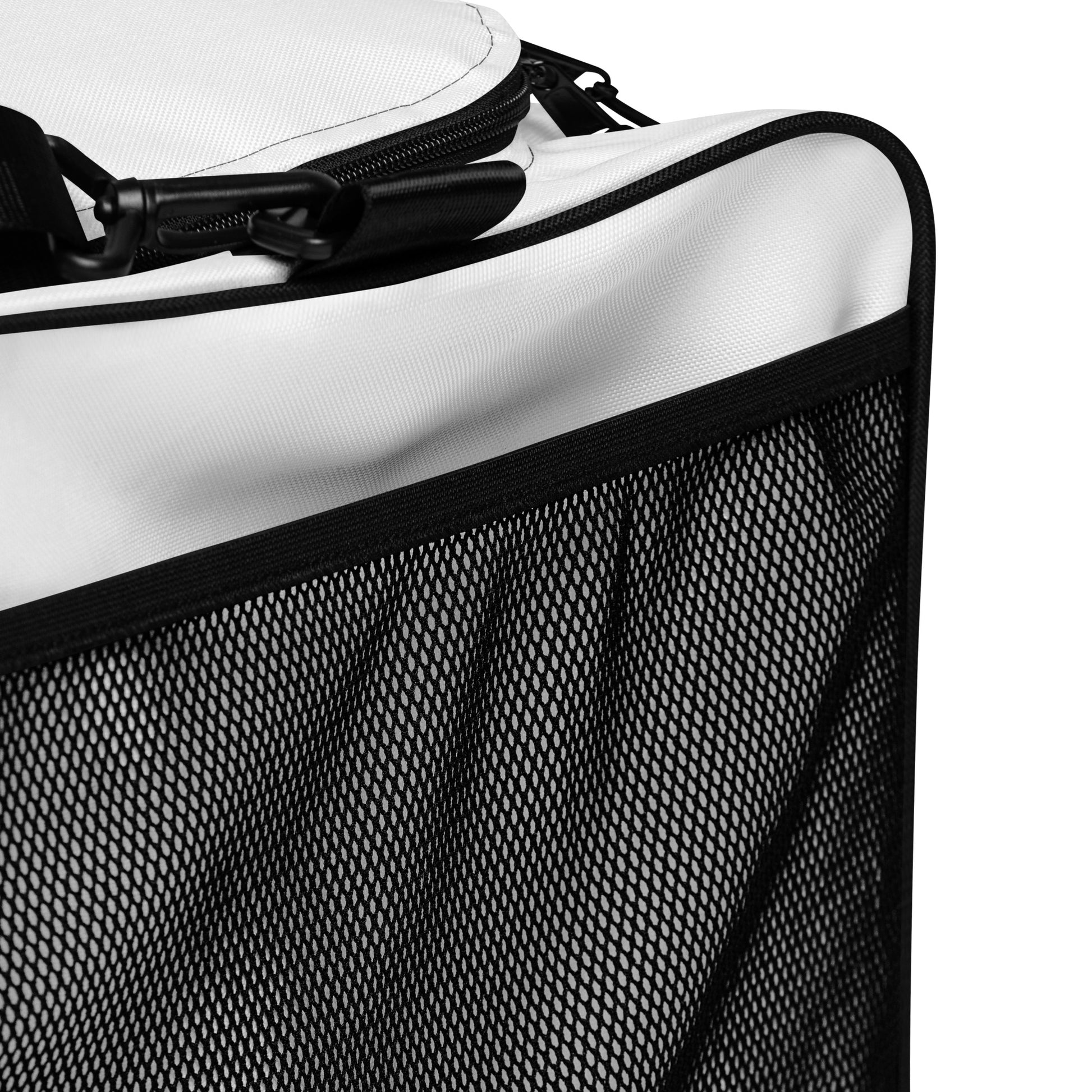 Close-up of black mesh side panel and zipper edge on a white duffle bag
