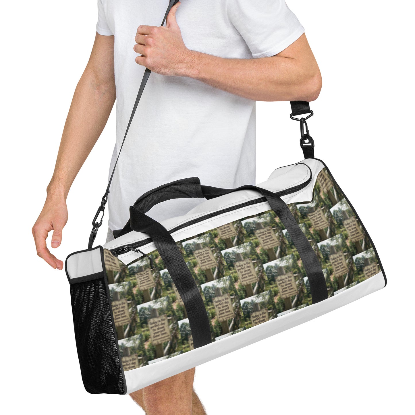 White duffle bag with black straps, zip-top opening, and green-brown graphic print