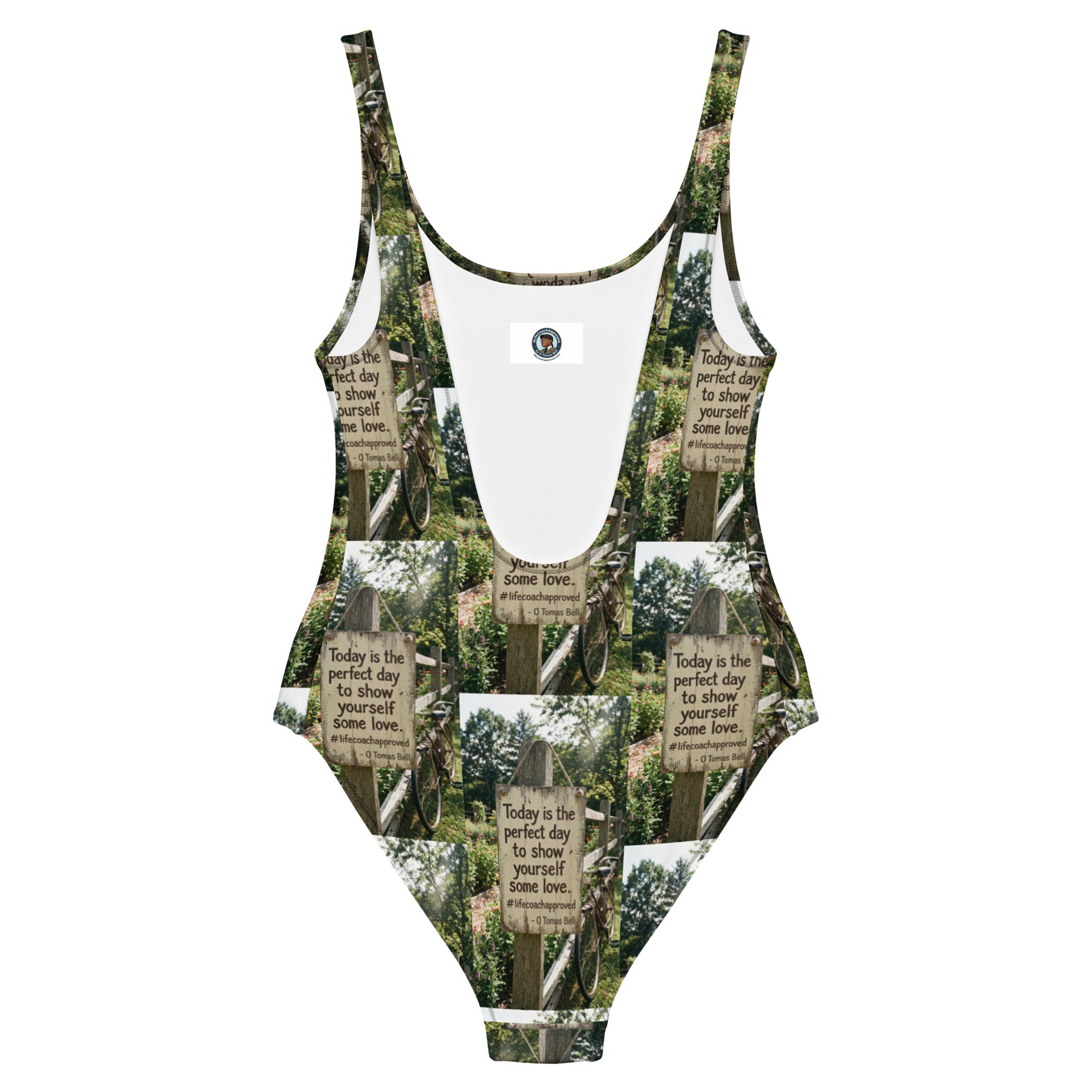 Self love one-piece swimsuit with green-and-white graphic sign print and scoop neckline.