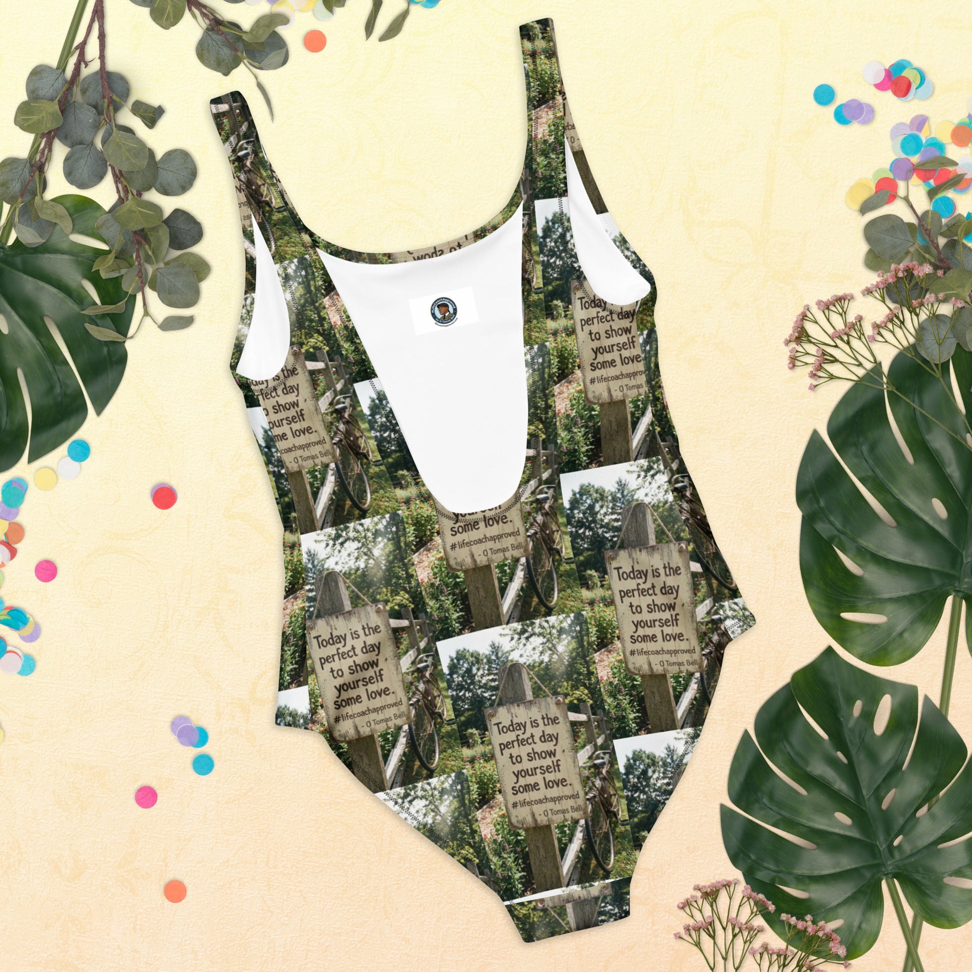 Self love one-piece swimsuit with green-and-white sign graphic and contrast neckline binding.