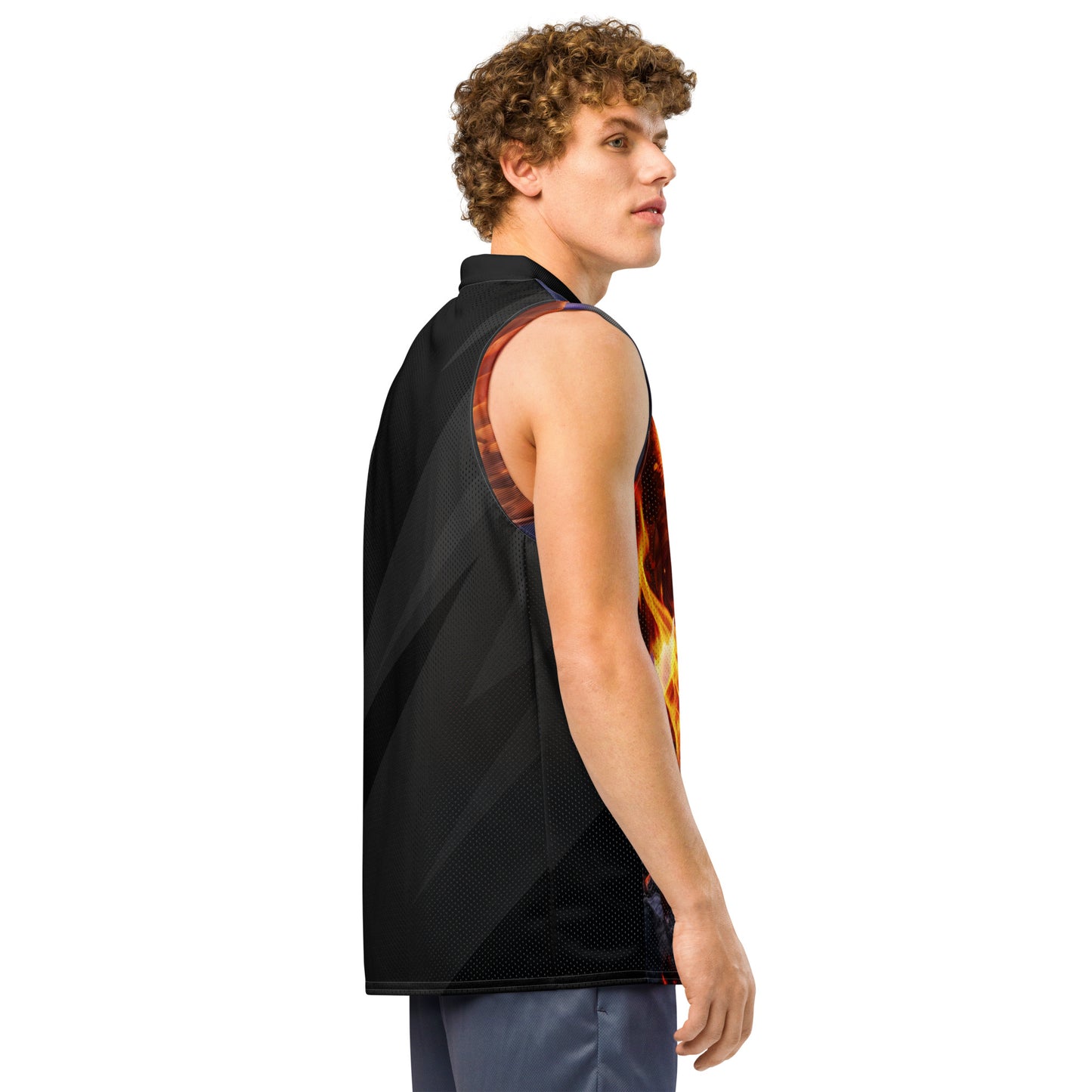 Model side view of basketball jersey, black mesh back panel with orange shoulder accents.