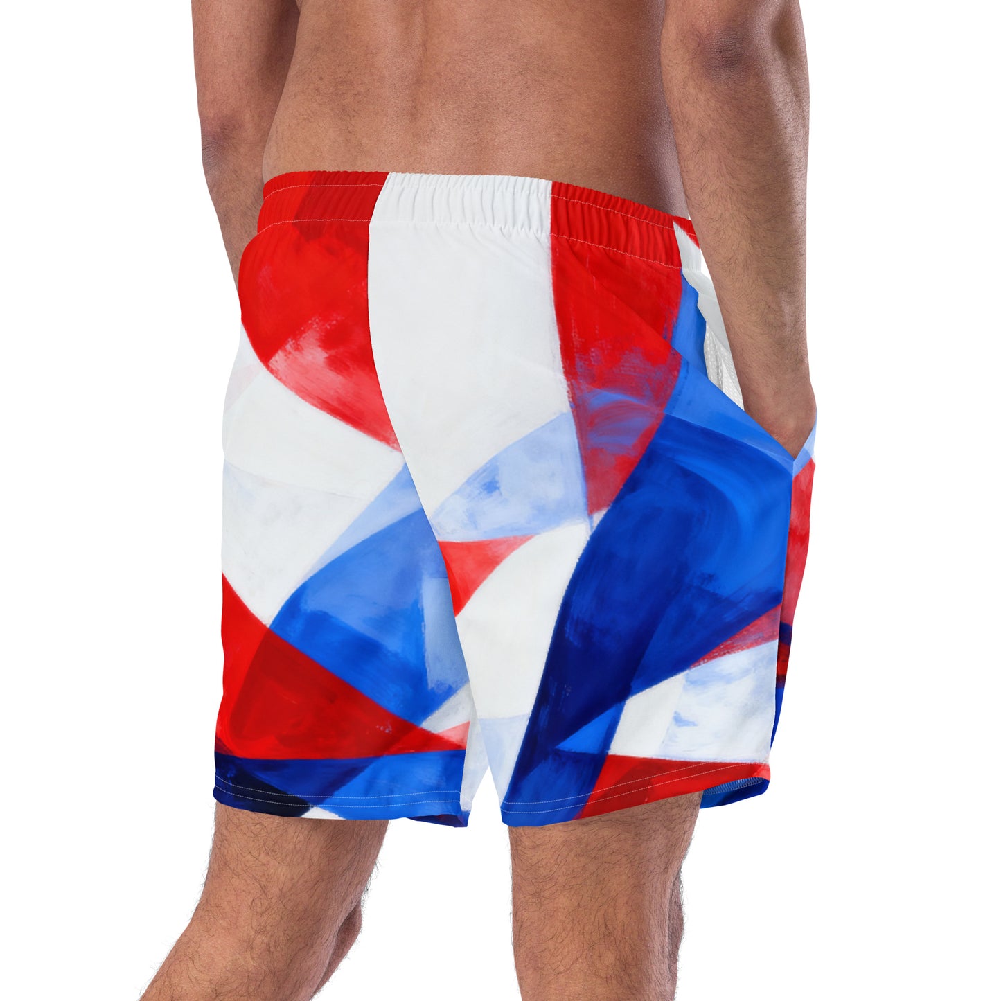 Men's swim trunks close-up, red, white, and blue geometric panel pattern.