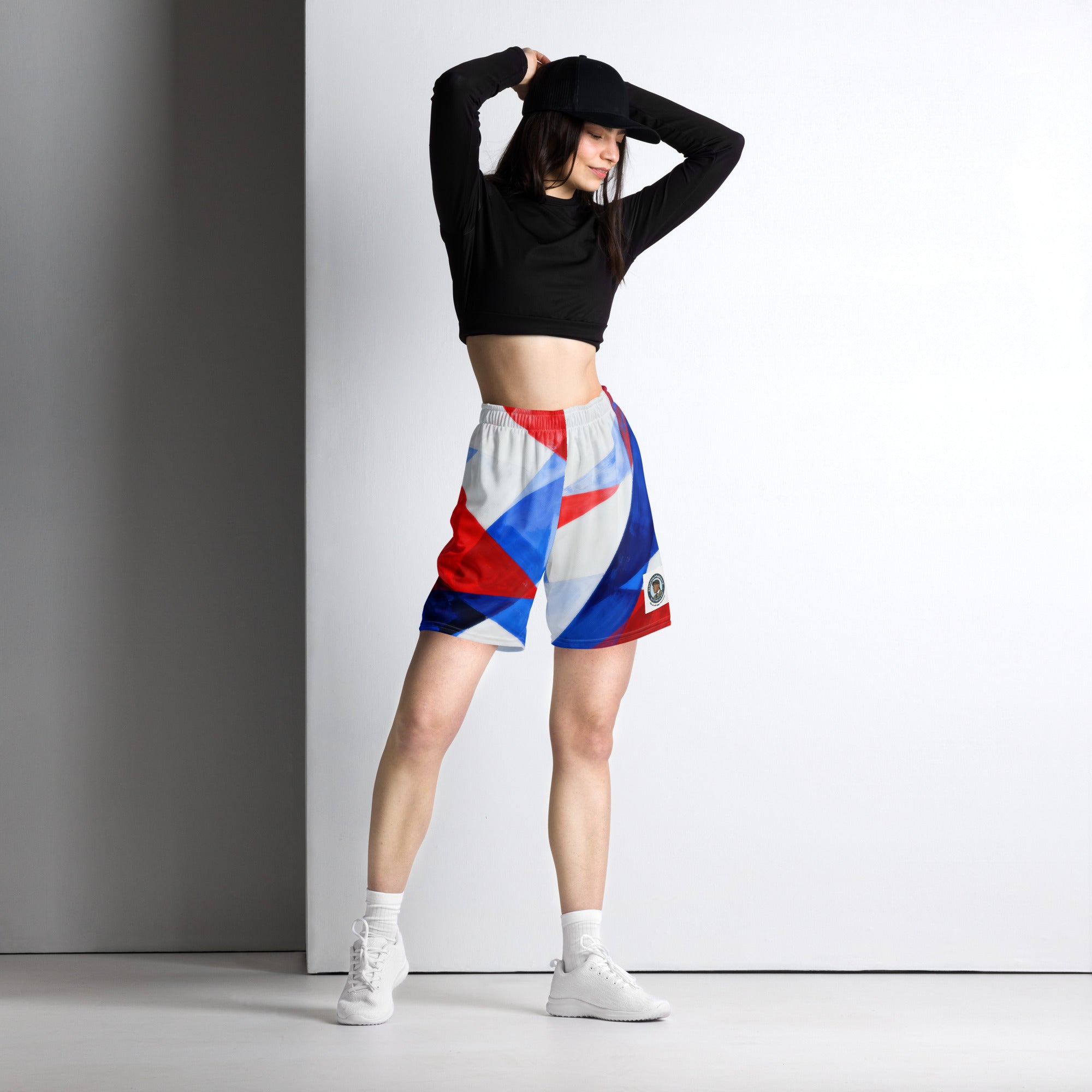 Mesh athletic shorts with bold red, white, and blue geometric pattern; elastic waistband