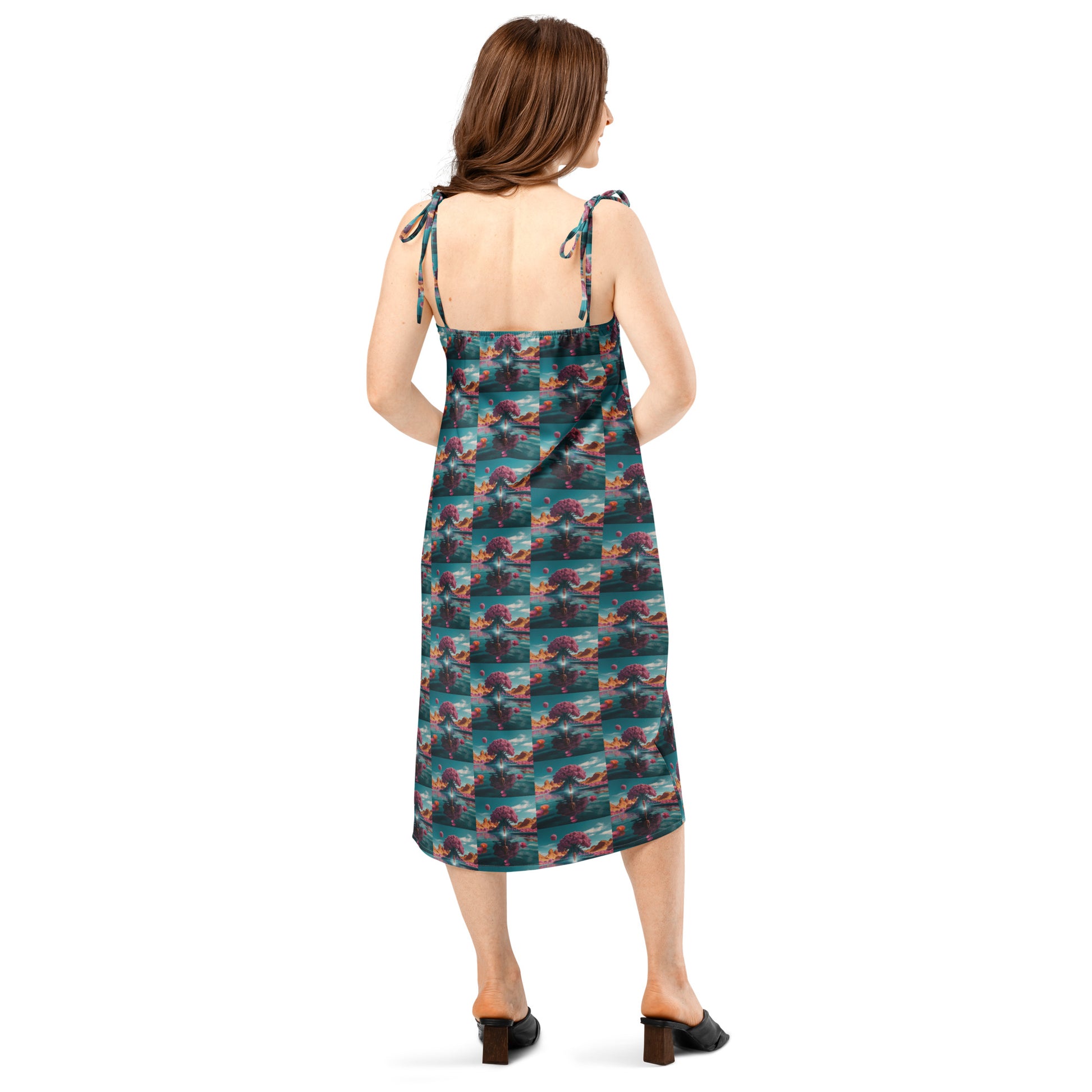 Back view of tie-strap midi dress with adjustable straps and ocean-print paneling.