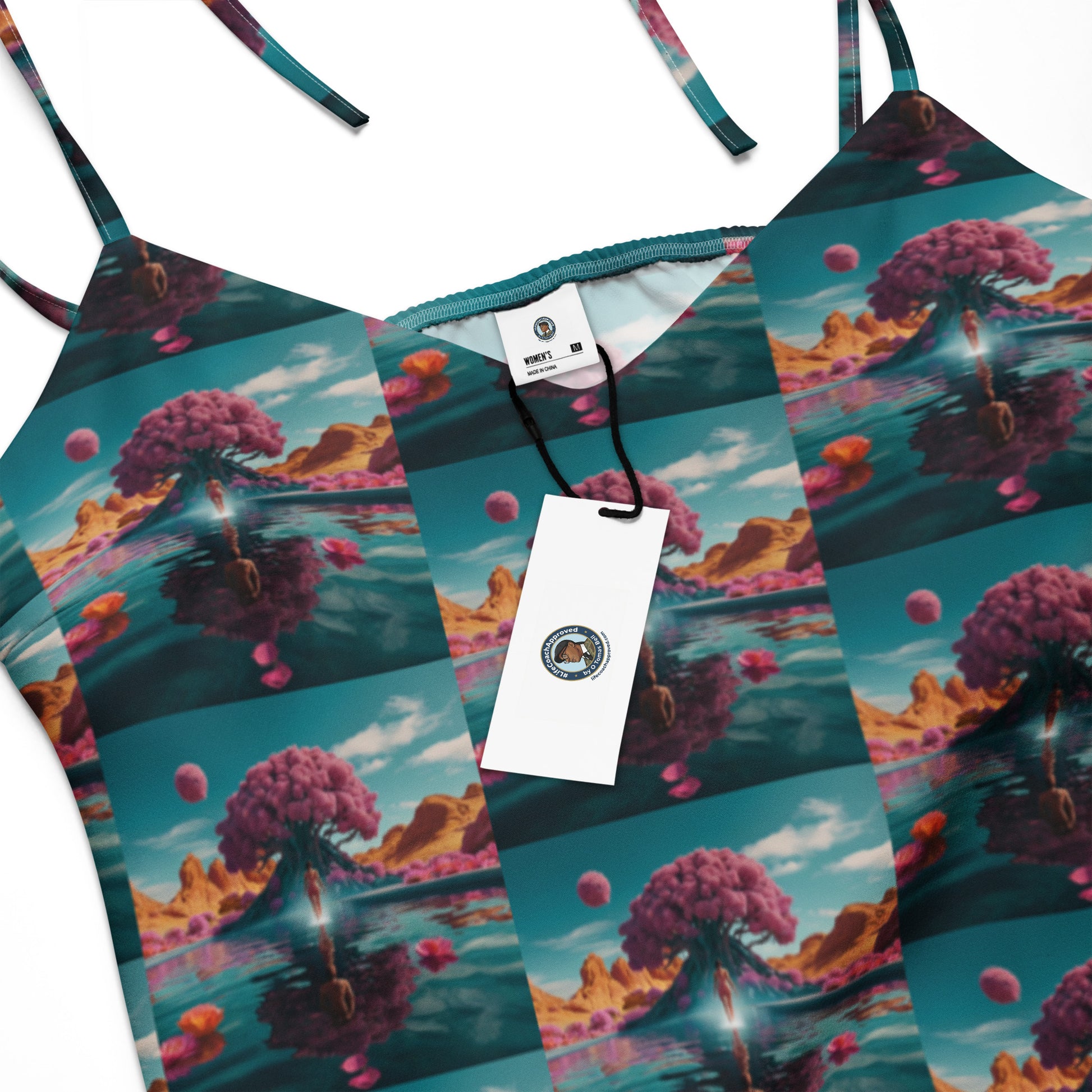 Close-up of ocean-print tie-strap midi dress fabric with coral clouds and bubbles.