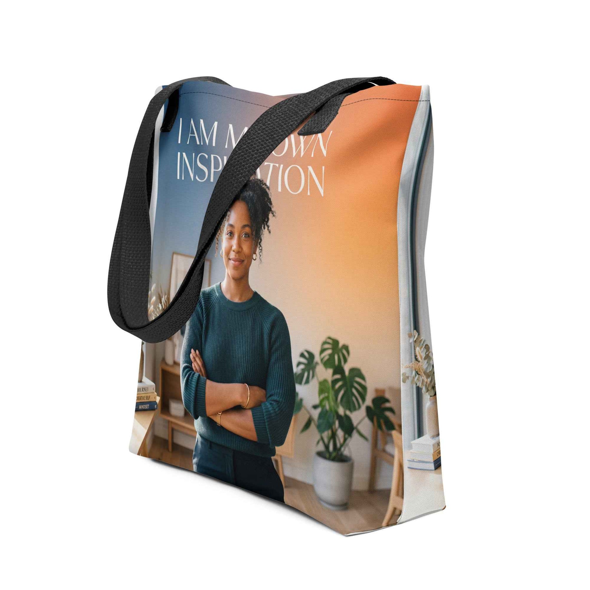 Printed tote bag with black strap and photo graphic, “I AM MY OWN INSPIRATION” text.