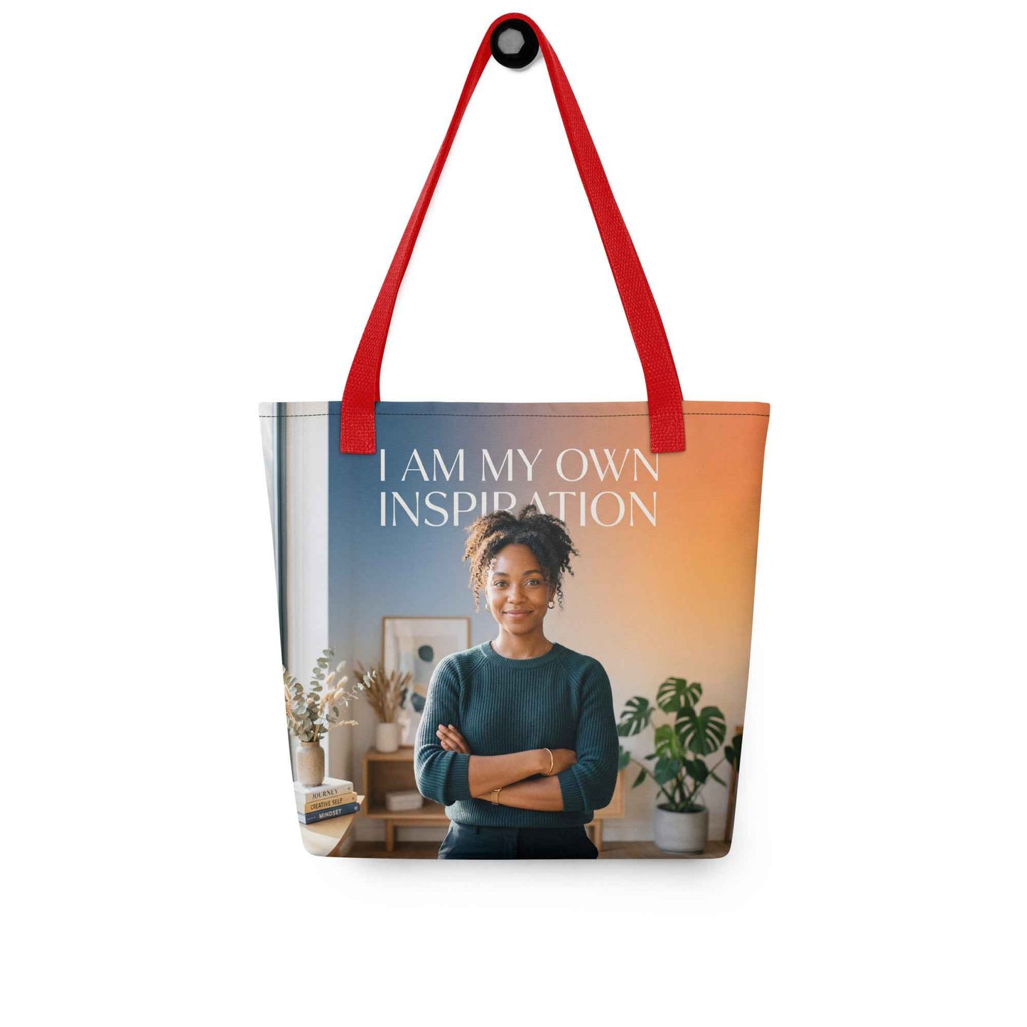 Printed tote bag with red handles; “I AM MY OWN INSPIRATION” text over portrait image.