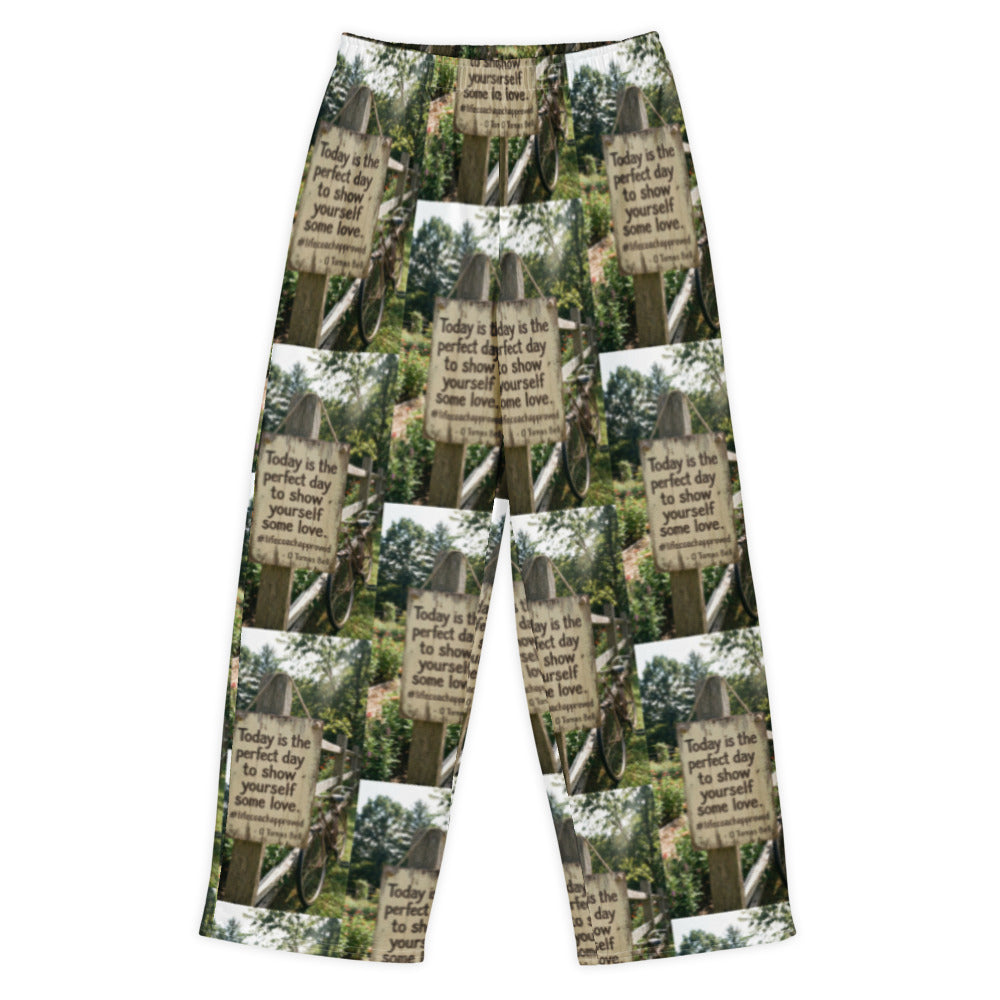 Wide-leg cotton pants with green foliage photo collage and motivational text print, flat lay