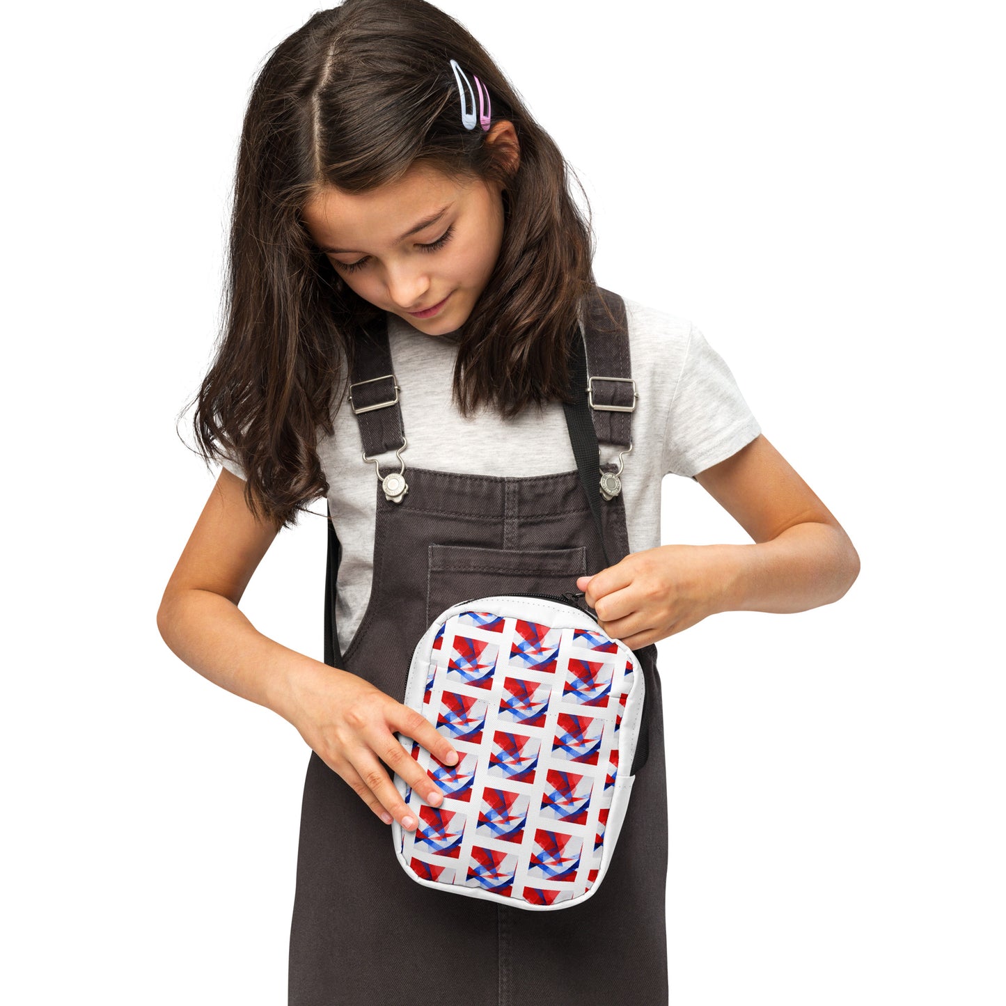 Utility crossbody bag with white UK flag pattern, held near chest with black strap and zipper.