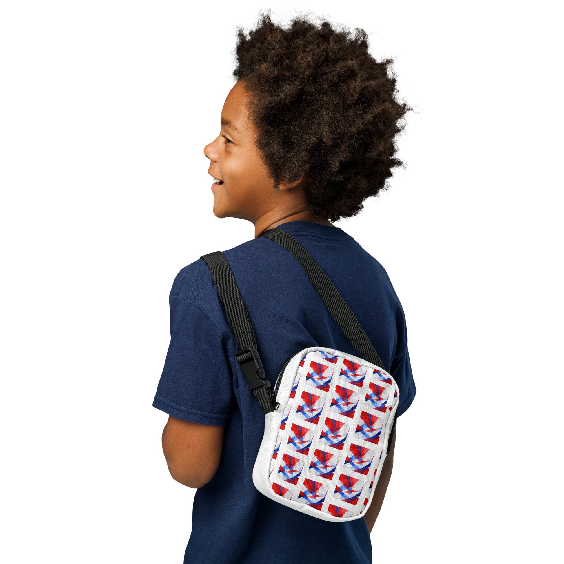 Utility crossbody bag with white UK flag pattern, shown from side with black strap and rounded shape.