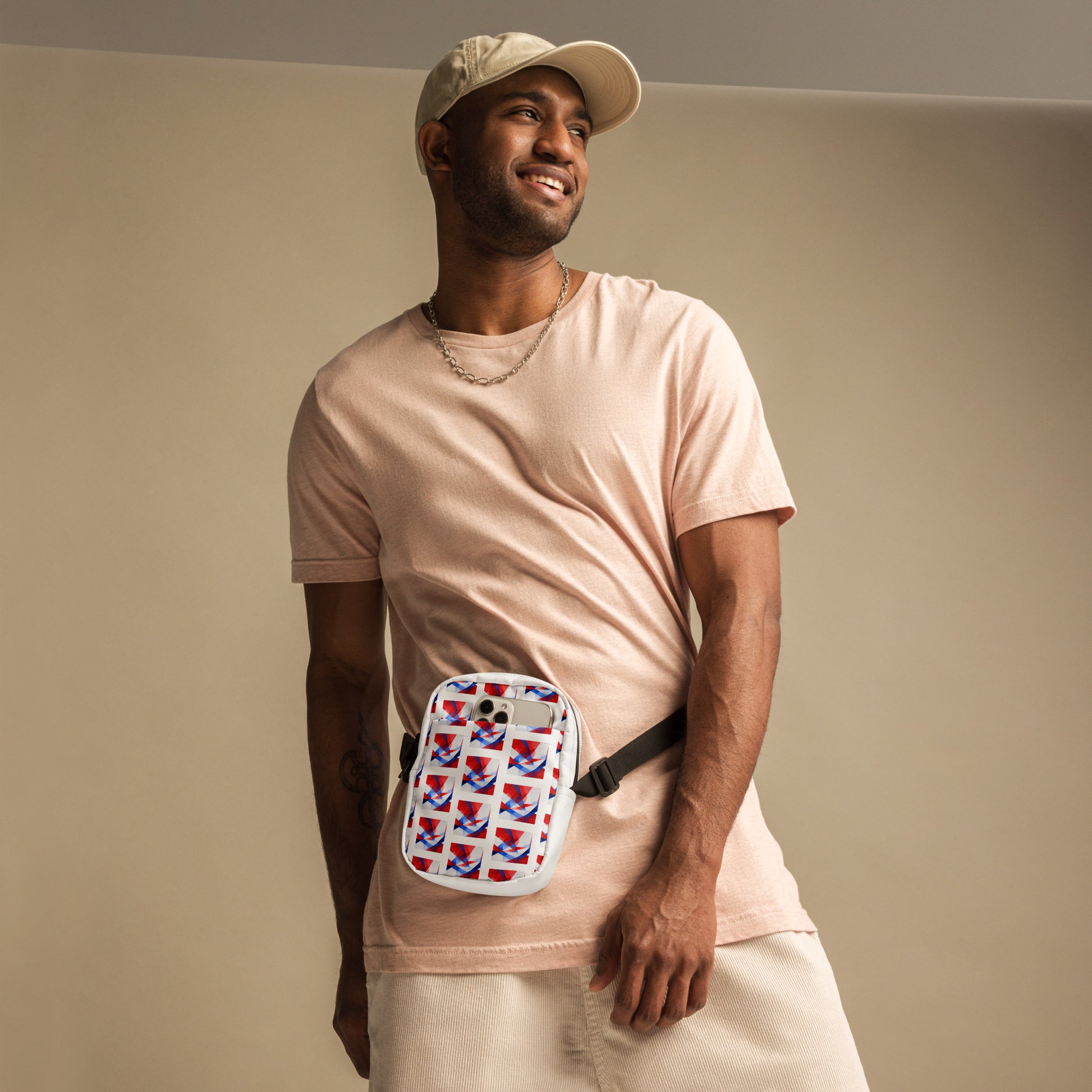 Utility crossbody bag with white UK flag pattern and black strap, worn across chest on a man.