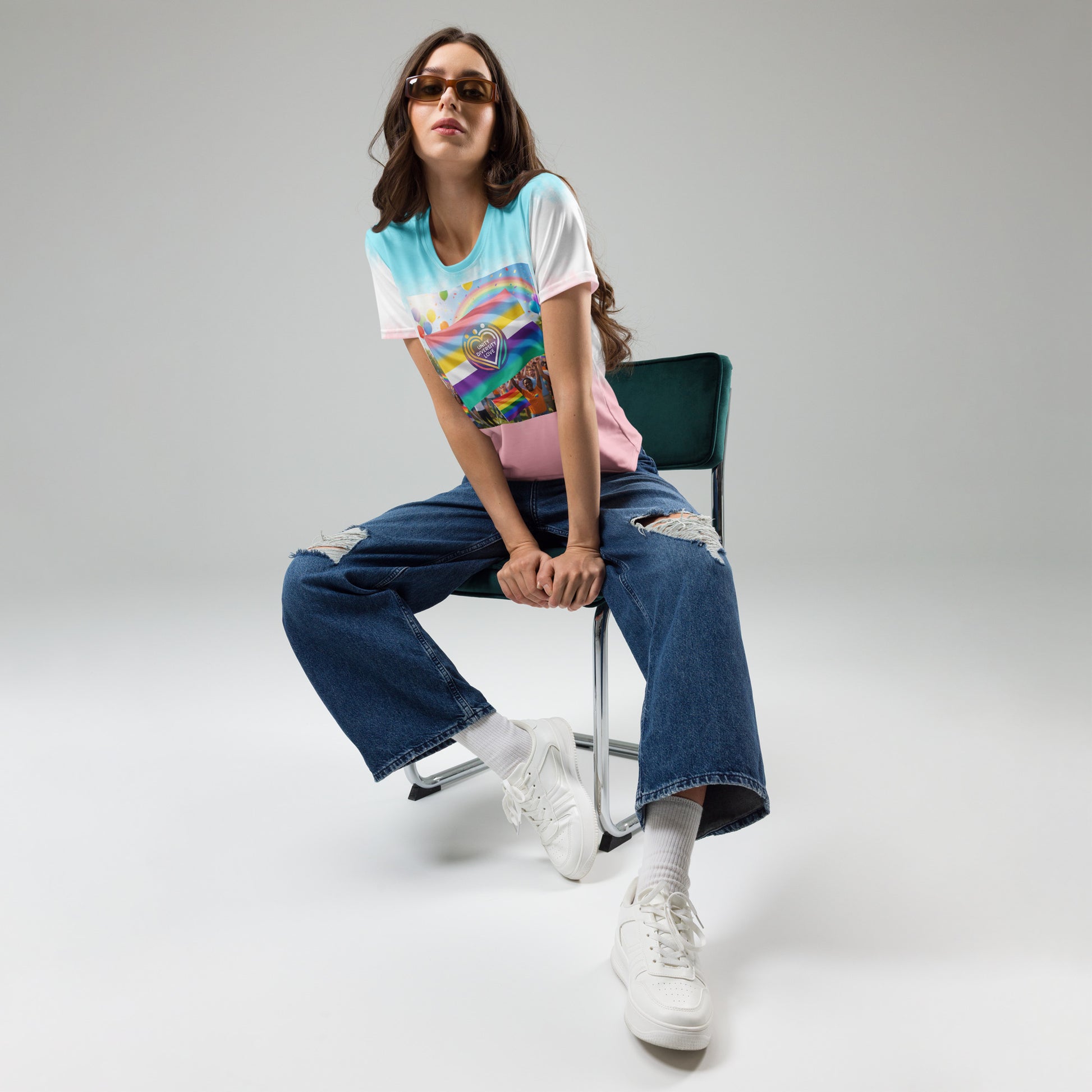 Women’s rainbow graphic T-shirt with pink hem and white sleeves, worn with jeans